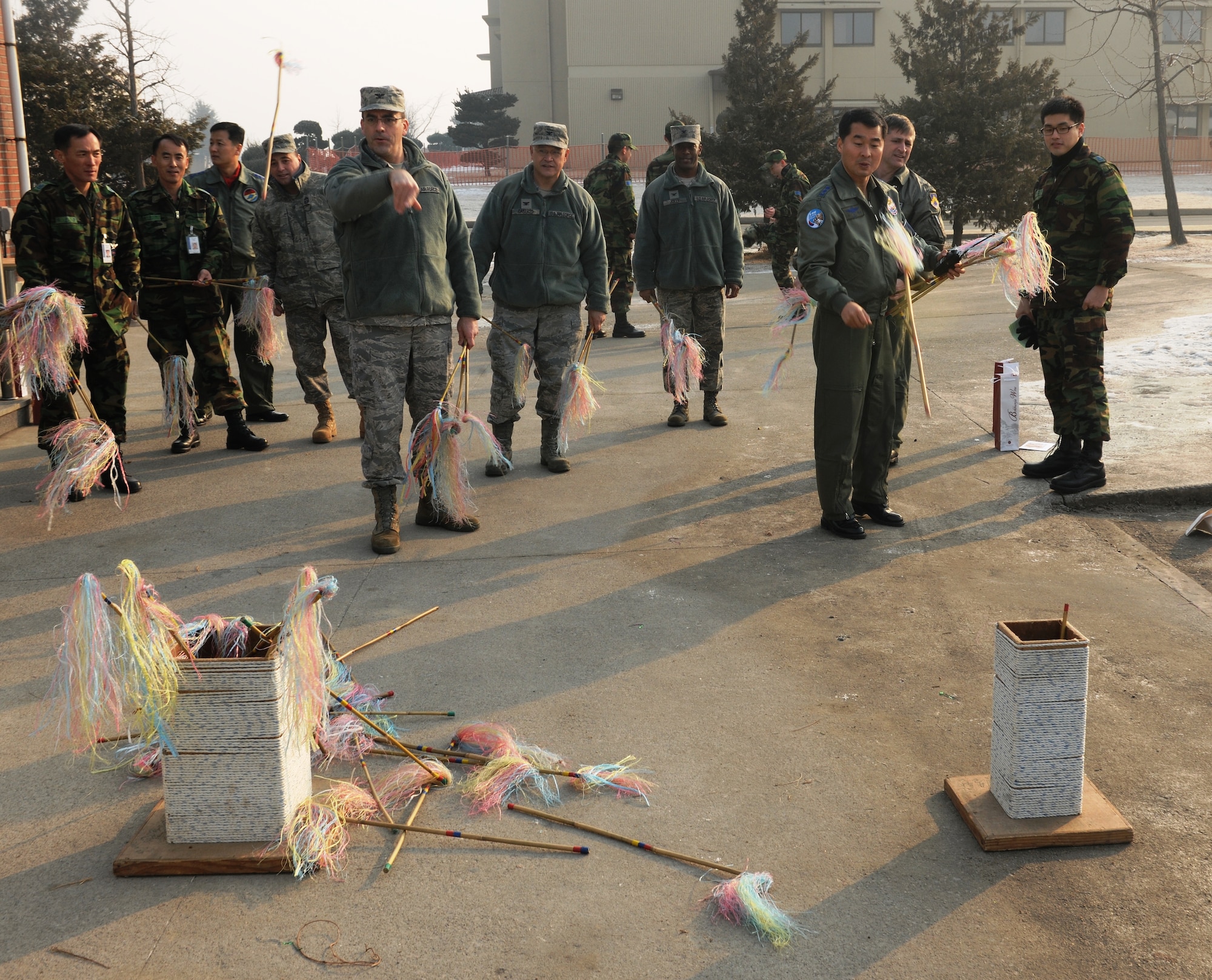 KUNSAN AIR BASE, Republic of Korea -- Col. Richard Palmieri, 8th Mission Support Group commander, and Lt. Col. Kong Seung-Bae, Republic of Korea Air Force 111th Fighter Squadron commander, take their turns at playing the traditional Korean game of To-Hoe during a Lunar New Year ceremony in the Republic of Korea Air Force base exchange Feb. 3. The combined 8th FW and ROKAF 38th FG ceremony included a memorial service, ceremonial bowing, a traditional Korean breakfast and traditional games. (U.S. Air Force photo/Senior Airman Ciara Wymbs)