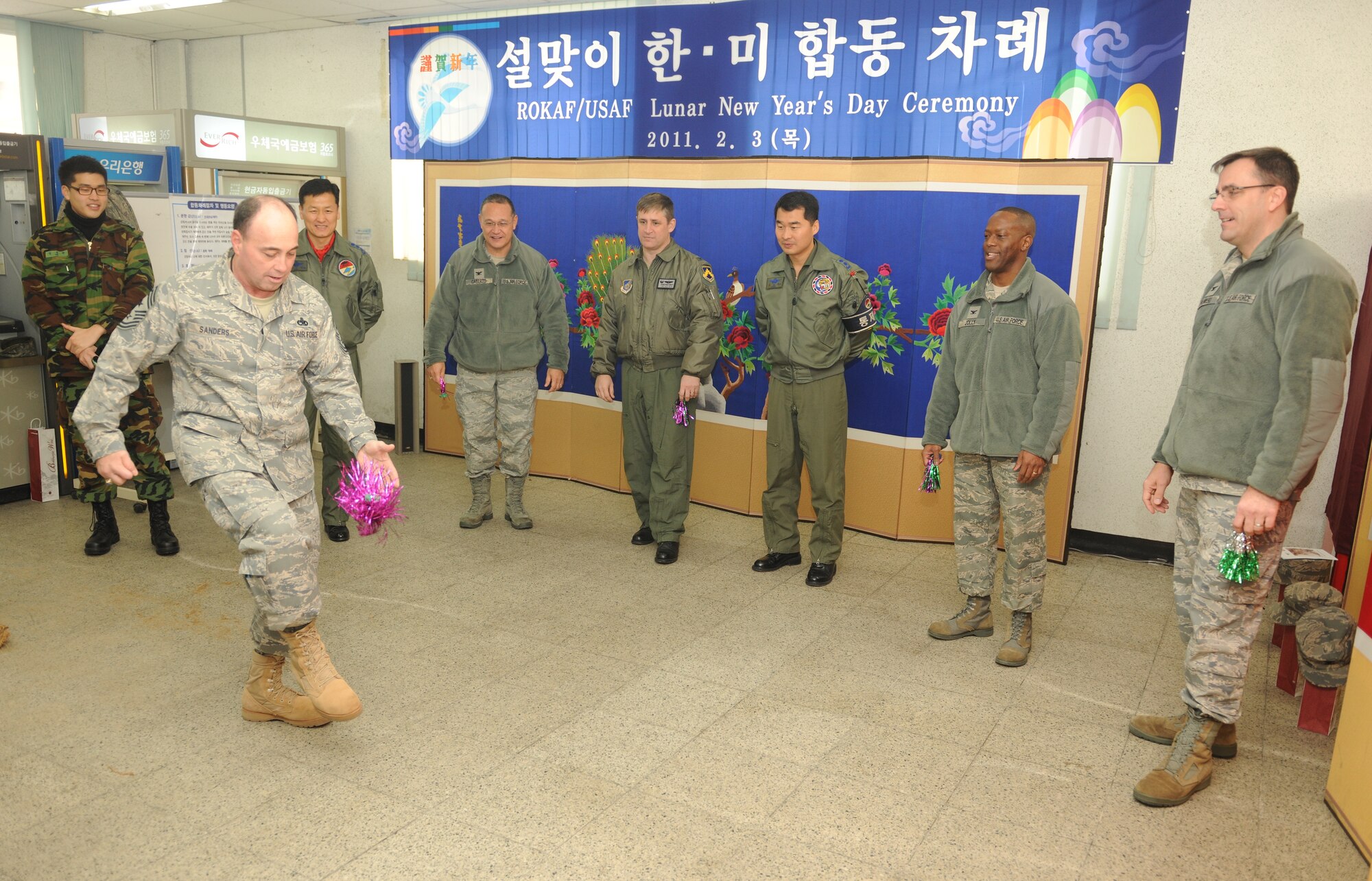 KUNSAN AIR BASE, Republic of Korea -- Chief Master Sgt. James Sanders, 8th Fighter Wing command chief, plays the traditional Korean game of Chegi during a Lunar New Year ceremony in the Republic of Korea Air Force base exchange Feb. 3. The combined 8th Fighter Wing and ROKAF 38th Fighter Group ceremony included a memorial service, ceremonial bowing, a traditional Korean breakfast and traditional games. (U.S. Air Force photo/Senior Airman Ciara Wymbs)