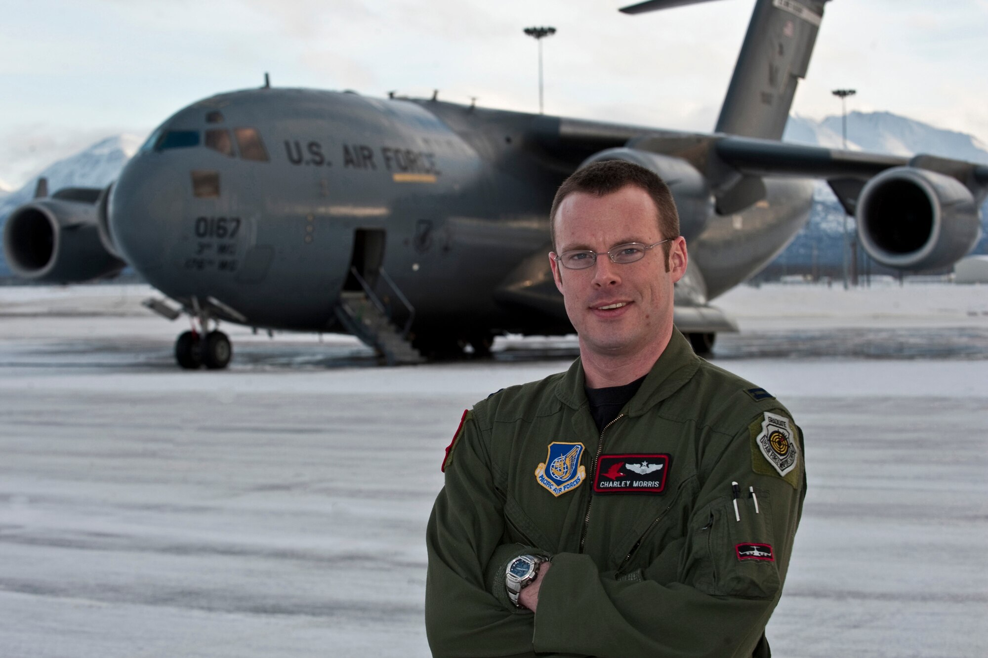 JOINT BASE ELMENDORF-RICHARDSON, Alaska -- Capt. Allen Morris, 517th Airlift Squadron weapons officer and tactics flight commander, makes poses in front of a C-17 Globemaster III before taking off for a flight Jan. 27. Captain Morris was recently named the winner of the 2010 Daedalian Exceptional Pilot Award at the Pacific Air Forces level. (Air Force photo by Airman 1st Class Christopher Gross)