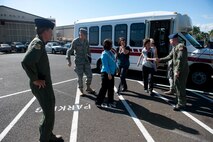 Capt. John Cortney, 15th Operations Support Squadron C-17 Instructor Pilot, greets Mrs. Lorrie Kresge in front of the base operations building Feb. 3 at Joint Base Pearl Harbor Hickam, Hawaii. During her visit to base operations, Mrs. Kresge  was briefed on the building's history as well as its function within the wing. (U.S. Air Force photo/Staff Sgt. Nathan Allen)