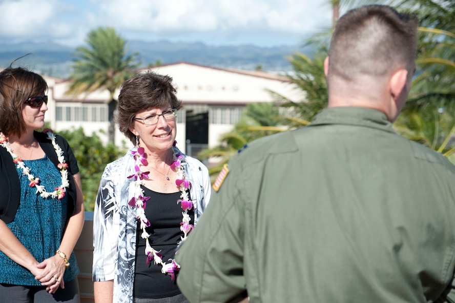 Capt. John Cortney, 15th Operations Support Squadron C-17 Instructor Pilot, talks with Mrs. Lorrie Kresge about 15th Wing history from the "Crow's Nest" above the base operations building Feb. 3 at Joint Base Pearl Harbor Hickam, Hawaii. During her visit to base operations, Mrs. Kresge  was briefed on the building's history as well as its function within the wing. (U.S. Air Force photo by Staff Sgt. Nathan Allen)