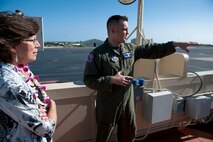 Capt. John Cortney, 15th Operations Support Squadron C-17 Instructor Pilot, points out areas of interest to Mrs. Lorrie Kresge on the flightline from the "Crow's Nest" above the base operations building Feb. 3 at Joint Base Pearl Harbor Hickam, Hawaii. During her visit to base operations, Mrs. Kresge  was briefed on the building's history as well as its function within the wing. (U.S. Air Force photo/Staff Sgt. Nathan Allen)