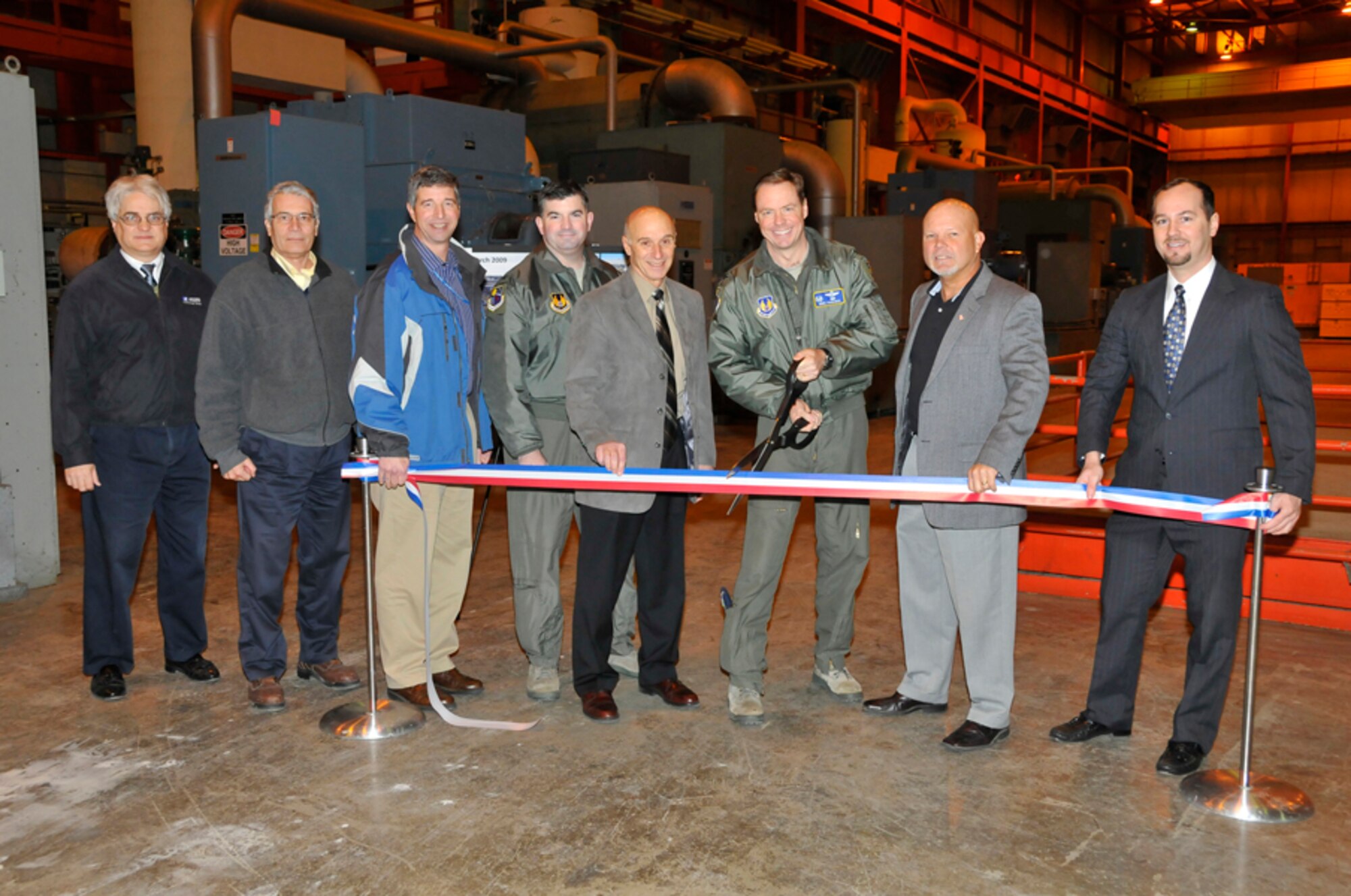 AEDC Commander, Col. Michael Panarisi, cuts the ribbon marking the completion of Phase I of the TEDAC facility Jan. 20. Also pictured are Dr. David Elrod, ATA general manager; David Browning, ATA TEDAC program manager; Kirk Rutland, Maintenance Division deputy chief; Col. William Bailey, Test Division chief; Ron Polce, Test Systems Division chief; Mike Abeln, U.S. Army Corps of Engineers, Mobile District Construction Division chief; and Kris Hughes, Air Force TEDAC program manager. (Photo by Gary Johnson)