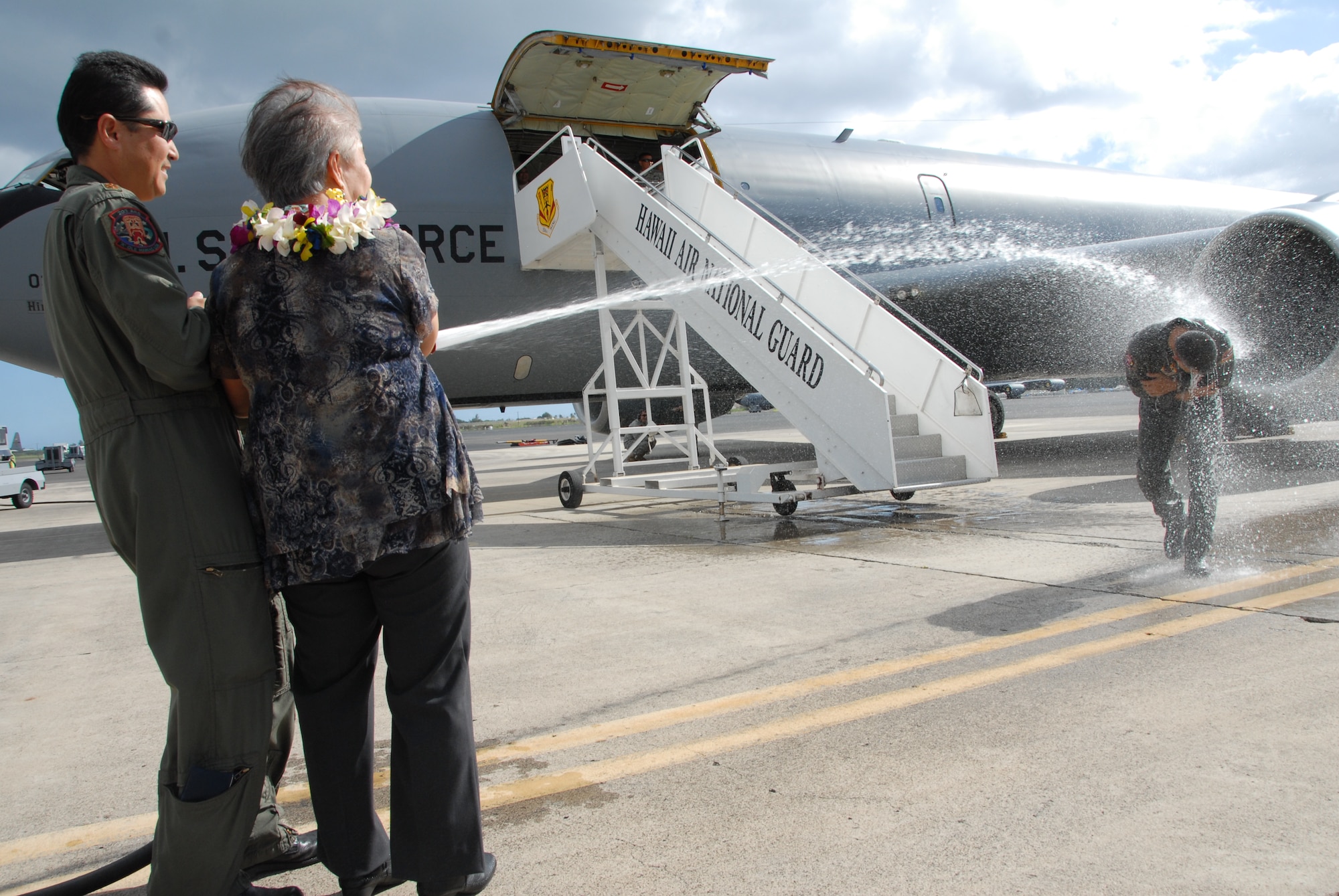 Brig. Gen. Joseph K. Kim, outgoing 154th Wing commander, returns from his final KC-135 flight on Joint Base Pearl Harbor-Hickam, Hawaii, Feb. 3 and gets hosed down by Maj. Scott Oka, 203rd Air Refueling Squadron and a surprise out-of-state visitor; his Mom. The Air Force has a tradition where aircrew, on completion of their final flight (‘fini-flight’) in an aircraft are usually met on arrival and hosed with water by their squadron members and family. Members of the 154th Wing and the active duty 15th Wing partnered together through total force integration to fly and maintain aircraft here. (U.S. Air Force Photo/Master Sgt. Kristen Stanley)