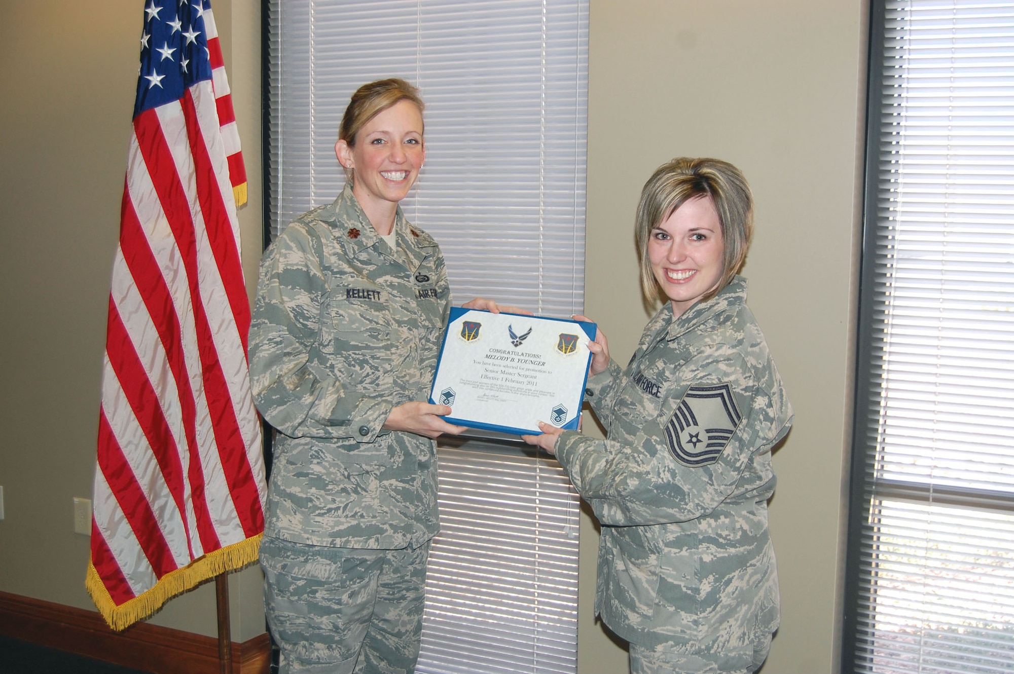 NELLIS AIR FORCE BASE, Nev. -- (Right) Senior Master Sgt. Melody Younger receives a certificate from Maj. Alexis Kellett, 926th Force Support Squadron commander, during her promotion ceremony here Feb. 1. Sergeant Younger is the manpower and personnel flight superintendent for the 926th FSS. (U.S. Air Force photo/Master Sgt. MaryAnn Martin)