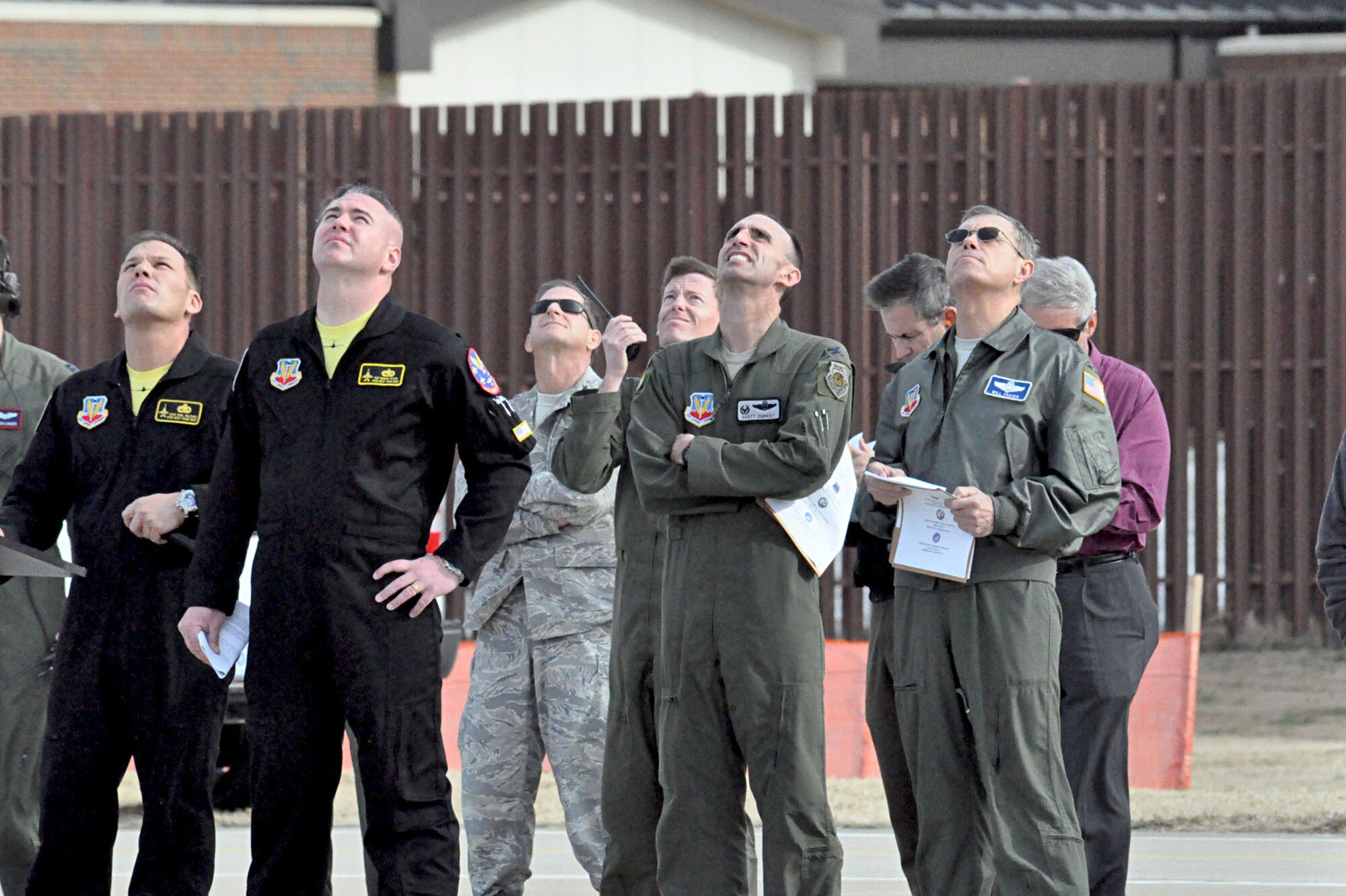 LANGLEY AIR FORCE BASE, Va. -- Gen. William M. Fraser III, (right), commander of Air Combat Command, Col. Scott Zobrist, (second from right), 388th Fighter Wing commander, Master Sgt. Carl Falcione, (second from left), F-16 Viper West Demonstration Team noncommissioned officer in charge, and Tech Sgt. Mike Bylica, (from left), Viper West team chief, look to the skies above Langley Air Force Base, Va., while the A-10 West Demo Team pilot performs a certification flight Feb. 2. Demonstration teams converged on Langley for three days to receive annual certification from ACC before beginning their 2011 air show tour. (U.S. Air Force photo/Staff Sgt. Ashley Hawkins)