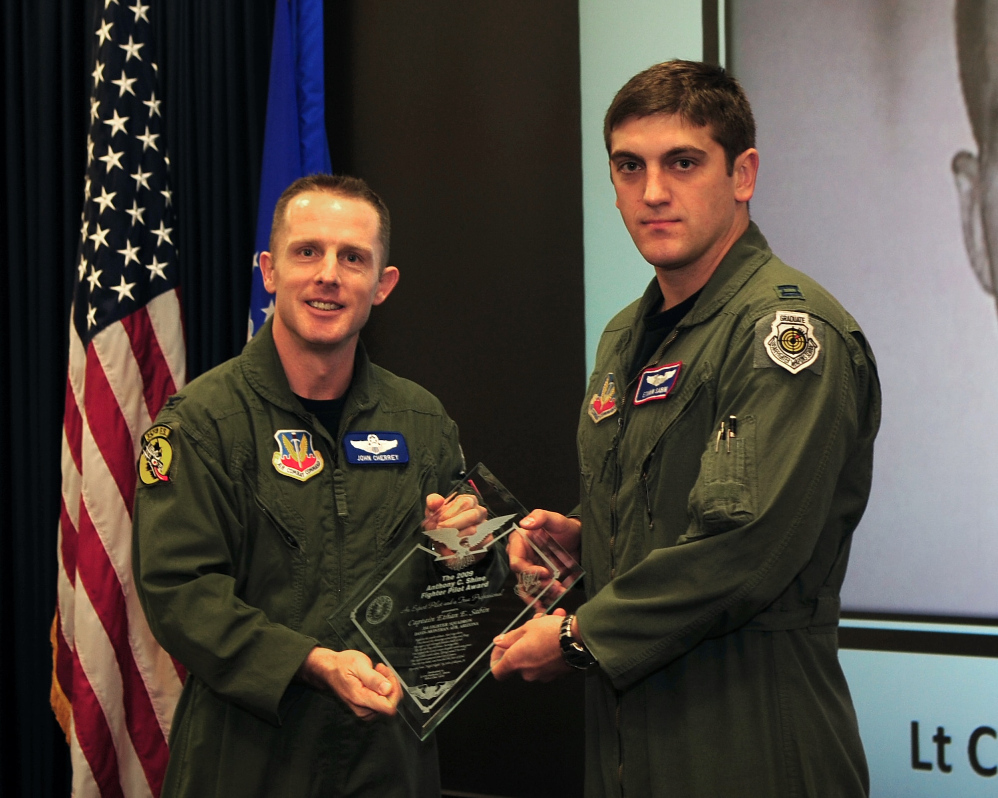 DAVIS-MONTHAN AIR FORCE BASE, Ariz. - Col. John Cherrey, 355th Fighter Wing commander, presents Capt. Ethan Sabin, a fighter pilot from the 354th Fighter Squadron, the 2009 Anthony Shine Award at the 355th FW headquarters building here Feb. 1. The Shine Award is given annually to a pilot who is exceptional at flying and also heavily involved with the community. (U.S. Air Force photo/Airman 1st Class Jerilyn Quintanilla)