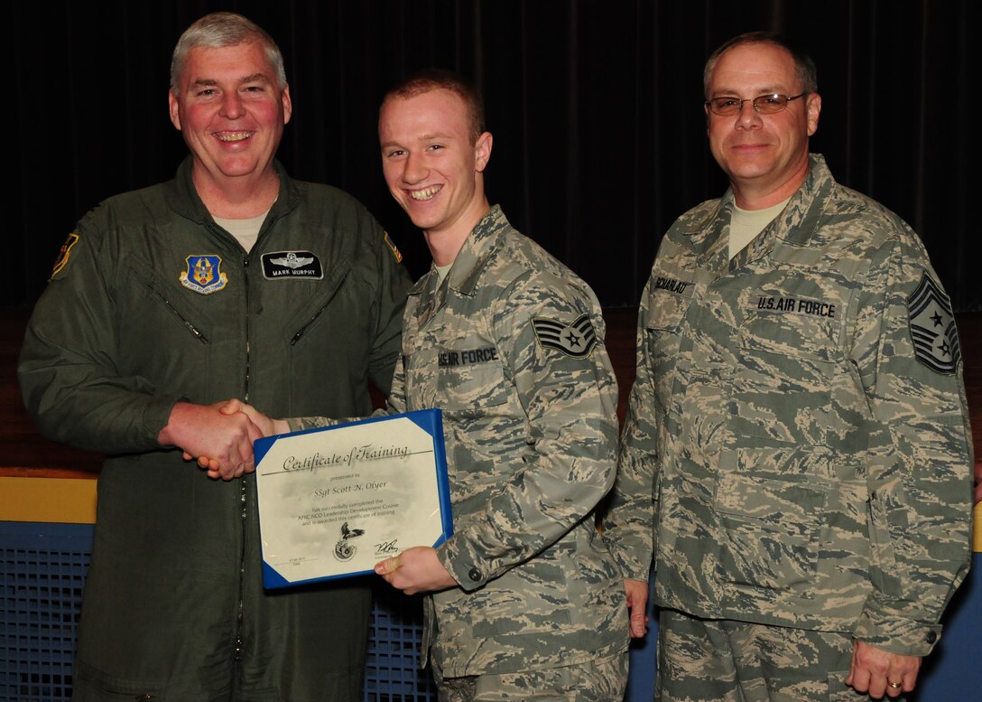 NIAGARA FALLS AIR RESERVE STATION, NY-Col. Mark Murphy (left) 914th Airlift Wing Vice Commander and 914th Airlift Wing Command Chief Master Sgt. Scott Scharlau congratulate Staff Sgt. Scott Olyer, 914th Communications Squadron for being one of 22 graduates from the class of the 2011 Non-Commissioned Officer Leadership Development Course recently held at the Niagara Falls Air reserve Station. (U.S. Air Force  photo by Mr. Peter Borys)