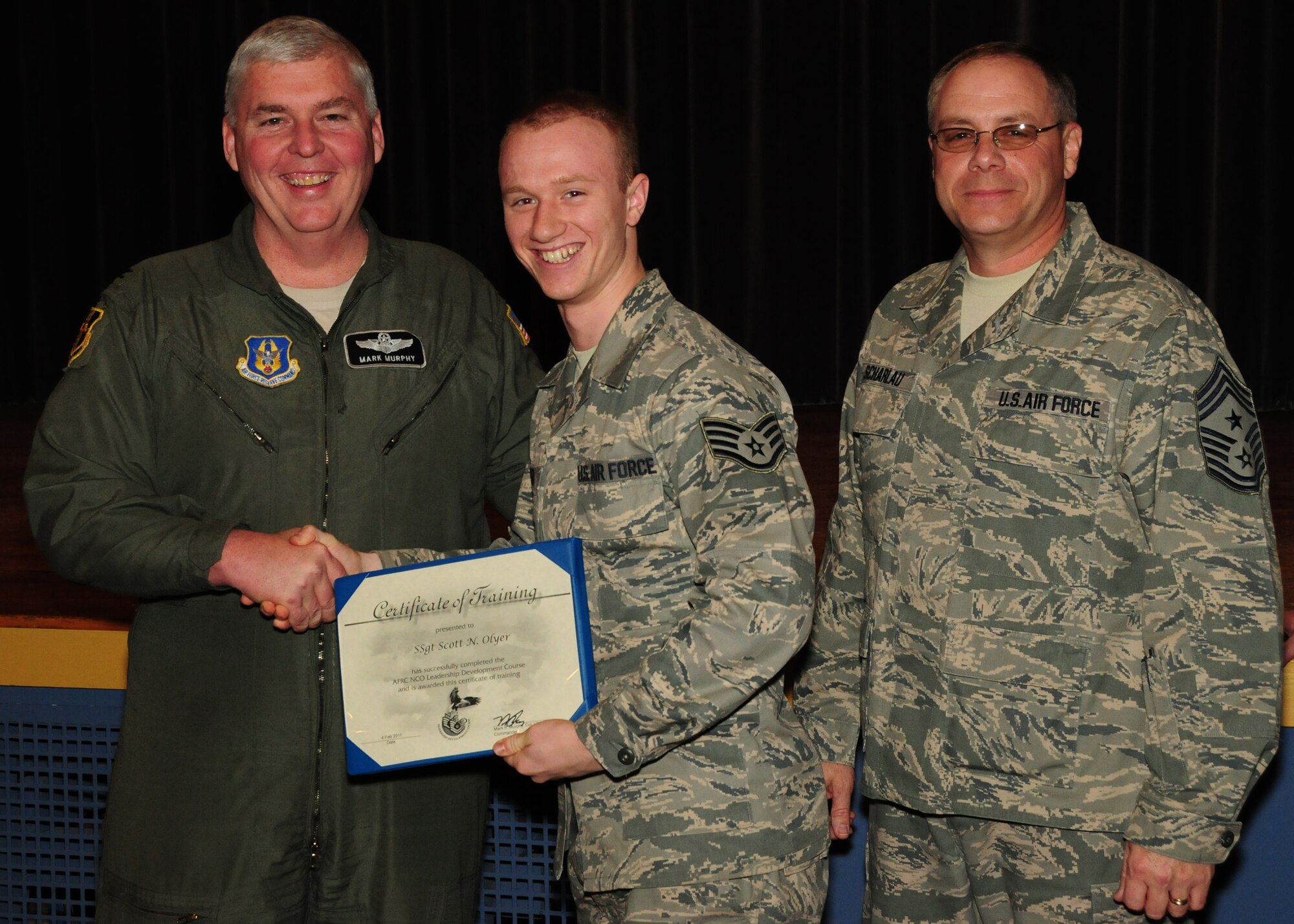 NIAGARA FALLS AIR RESERVE STATION, NY-Col. Mark Murphy (left) 914th Airlift Wing Vice Commander and 914th Airlift Wing Command Chief Master Sgt. Scott Scharlau congratulate Staff Sgt. Scott Olyer, 914th Communications Squadron for being one of 22 graduates from the class of the 2011 Non-Commissioned Officer Leadership Development Course recently held at the Niagara Falls Air reserve Station. (U.S. Air Force  photo by Mr. Peter Borys)