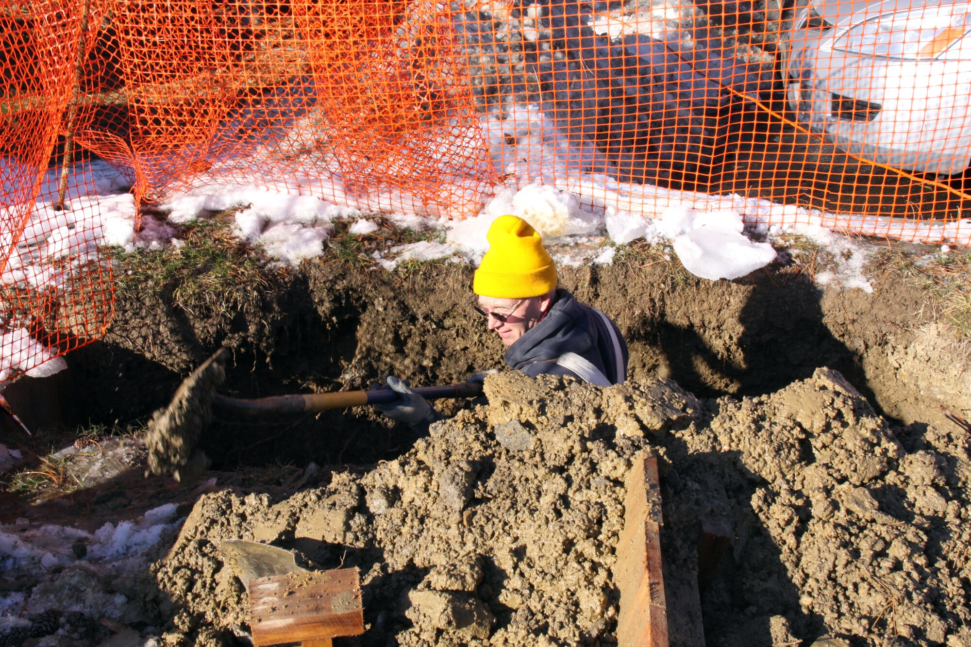Mr. George Walse, a contractor with Penn-Ohio Electrical, digs a hole to expose an area that is planned to be used to connect underground electrical pipes to a new transformer here, Feb. 2.  The work is part of a larger effort to convert the outside base electrical grid from above to below ground.