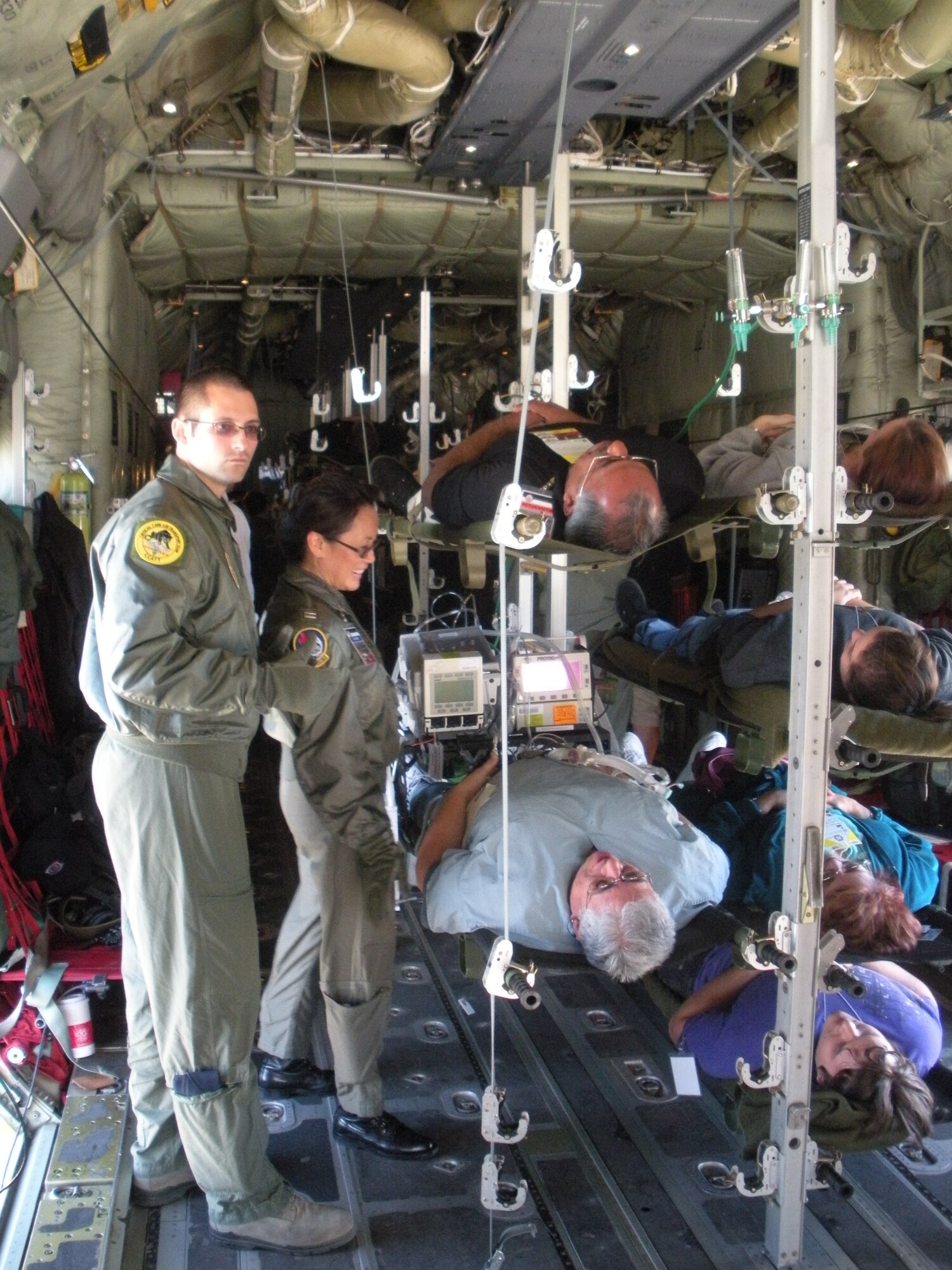 Staff Sgt. Christopher Martin and Capt. Majella Vito prepare to take a critical care patient off a C-130 during an exercise in Arizona Dec. 9. (U.S. Air Force Photo/Lt. Col. Michael Chesser)