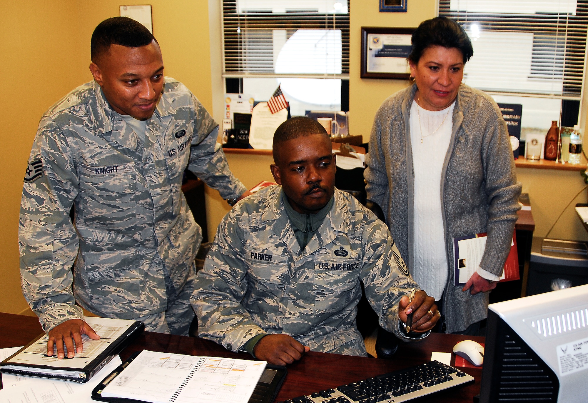 Master Sgt. Roderick Parker, center, recognized as AFRC’s 2010 Education and Traning SNCO, discusses an upcoming UTA schedule with staff members Staff Sgt. Aaron Knight and Master Sgt. Belinda Ray.