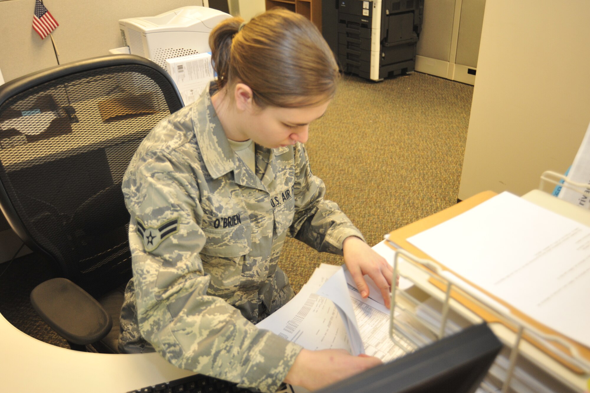 Airman 1st Class Sara O’Brien, 62nd Comptroller Squadron financial services technician, looks through a recently filed travel voucher to help a customer receive appropriate financial compensation Feb. 2 at Joint Base Lewis-McChord, Wash. (U.S. Air Force photo/Airman 1st Class Leah Young)