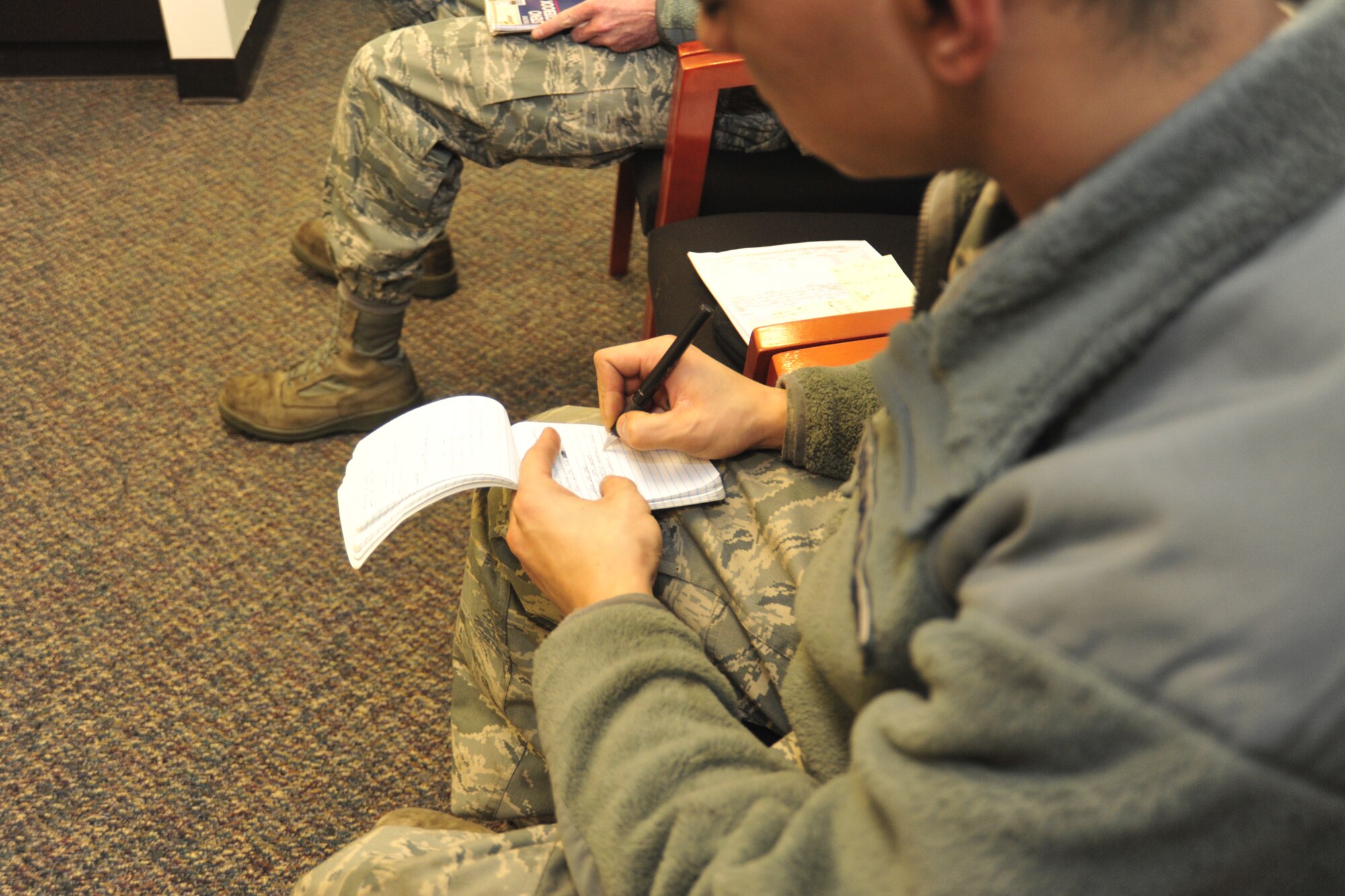 Airman 1st Class Cody Montoya, 62nd Maintenance Squadron aerospace ground equipment journeyman, writes down dates for his travel voucher before speaking with the 62nd Comptroller Squadron financial services Airmen Feb. 2 at Joint Base Lewis-McChord, Wash. (Airman 1st Class Leah Young)