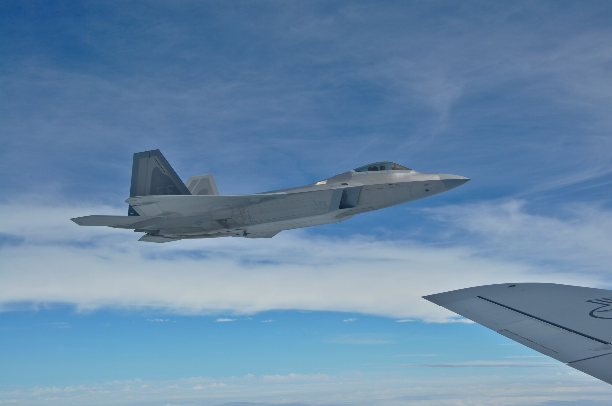 A pair of F-22 Raptors  practice refueling from a KC-135 Stratotanker on June 28, 2010. The F-22's were returning to Air Combat Command after participating in a joint training exercise with the 128th Air Refueling Wing.(US Air Force Photo by SSgt Jeremy Wilson / Released)