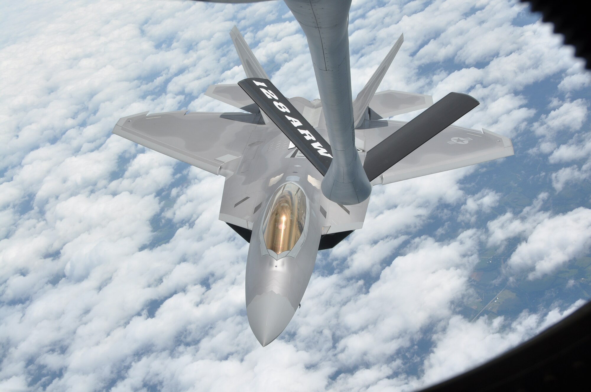 A pair of F-22 Raptors  practice refueling from a KC-135 Stratotanker on June 28, 2010. The F-22's were returning to Air Combat Command after participating in a joint training exercise with the 128th Air Refueling Wing.(US Air Force Photo by SSgt Jeremy Wilson / Released)