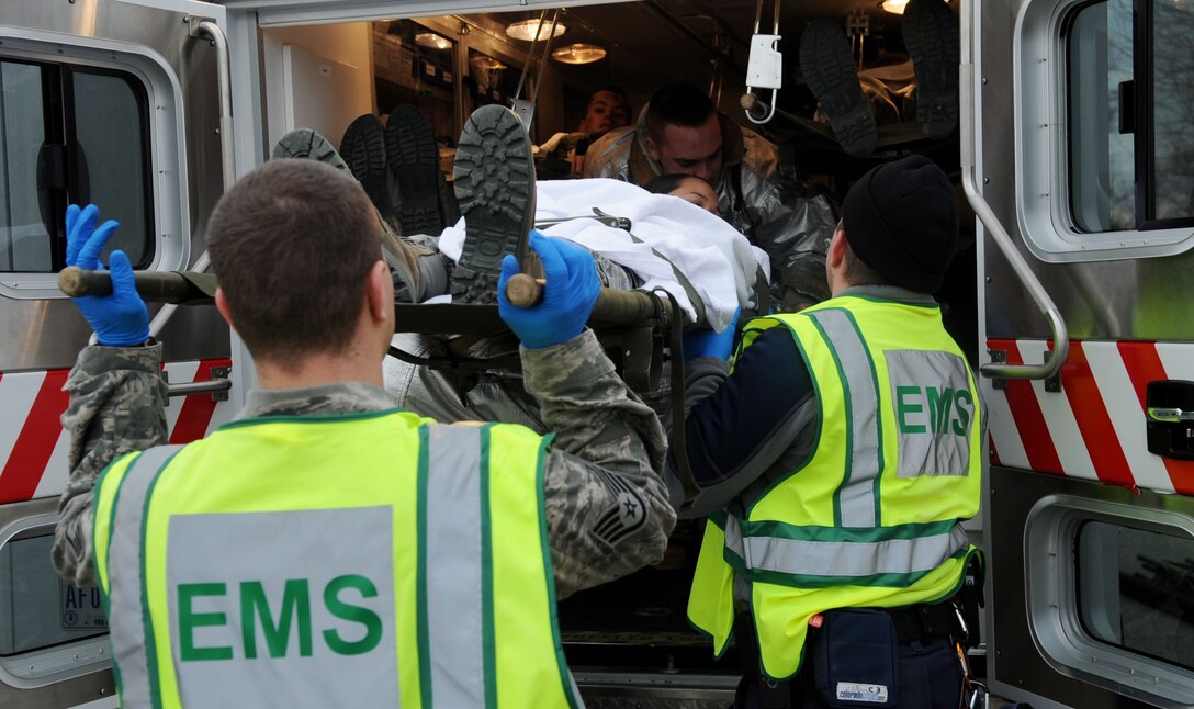 LANGLEY AIR FORCE BASE, Va. -- Emergency crews load patients with mock injuries into the back of an ambulance, after being triaged at the scene of a simulated explosion during a Major Accident Response Exercise Feb. 4. MAREs are held on a semi-annual basis to ensure emergency responders are trained and able to handle real-world incidents. (U.S. Air Force photo / Senior Airman Wesley Farnsworth) (RELEASED)