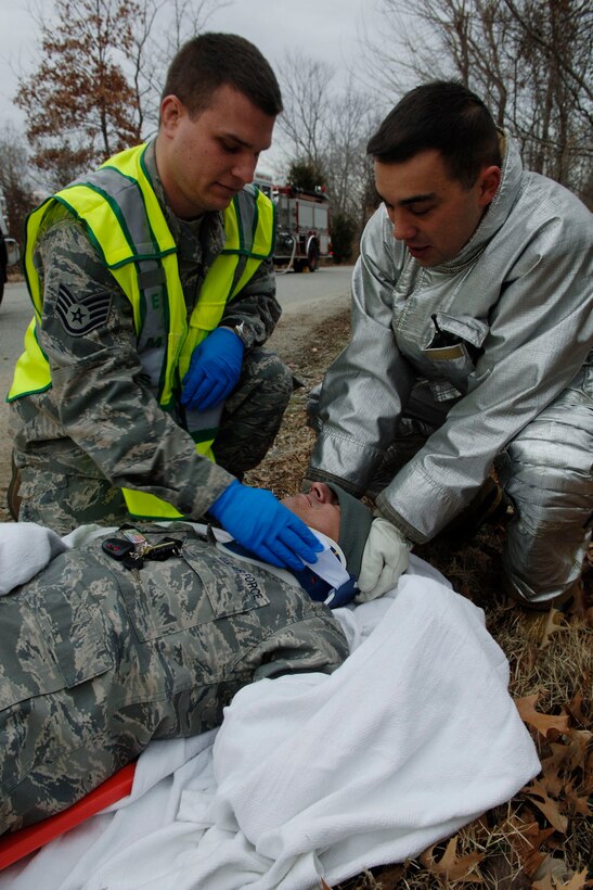 LANGLEY AIR FORCE BASE, Va. -- Staff Sgt. Daniel Beirl, 633d Medical Group Aerospace Squadron medical technician, and Staff Sgt. Jesse Zainey, 633d Civil Engineer Squadron Fire Department firefighter, stabilize and apply a neck brace on Senior Master Sgt. Tony Gurrola, 633 MDG Surgical Service Squadron superintendent and simulated accident victim, during a Toxic Industrial Chemical/Toxic Industrial Material simulation here, Feb. 4. The Major Accident Response Exercise was held as a required semi-annual evaluation to examine first respnders' ability to quickly react and stabilize real-world emergencies. (U.S. Air Force photo/Airman 1st Class Racheal Watson)(RELEASED)