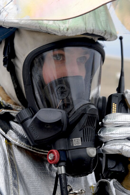 LANGLEY AIR FORCE BASE, Va. -- Staff Sgt. Joseph Dunn, 633d Civil Engineer Squadron Fire Department firefighter, calls in the status of injured personnel during a Toxic Industrial Chemical/Toxic Industrial Material simulation here, Feb. 4. This Major Accident Response Exercise is a semi-annual requirement that evaluates the base's immediate reaction to life-threatening emergencies. (U.S. Air Force photo/Staff Sgt. Ashley Hawkins)(RELEASED)