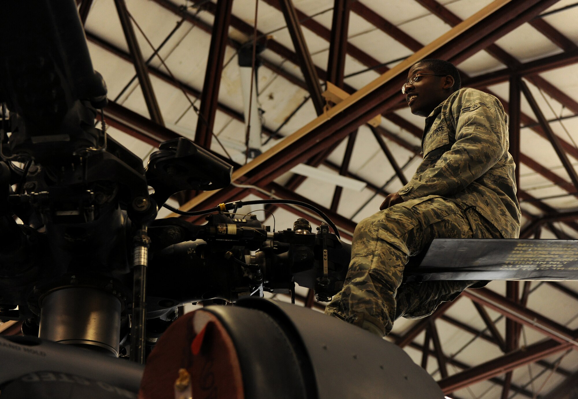 MOODY AIR FORCE BASE, Ga.-- Airman 1st Class Gabriel Thames, 41st Helicopter Maintenance Unit hydraulic technician, sits on a rotor blade of an HH-60G Pave Hawk helicopter as he documents serial numbers during recent maintenance. The 41st HMU does routine maintenance on all Pave Hawks stationed here to ensure all the helicopters are ready when the time comes.  (U.S. Air Force photo/Airman 1st Class Benjamin Wiseman)(RELEASED)