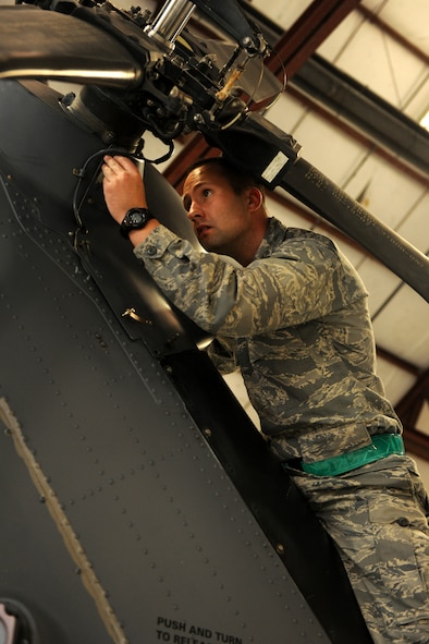MOODY AIR FORCE BASE, Ga.-- Senior Airman Casey Scaffide, 41st Helicopter Maintenance Unit crew chief, reattaches the forward tail box faring panel during maintenance of an HH-60G Pave Hawk helicopter recently. The forward tail box faring panel keeps debris and other objects from flying into the tail rotor. (U.S. Air Force photo/Airman 1st Class Benjamin Wiseman)(RELEASED)
