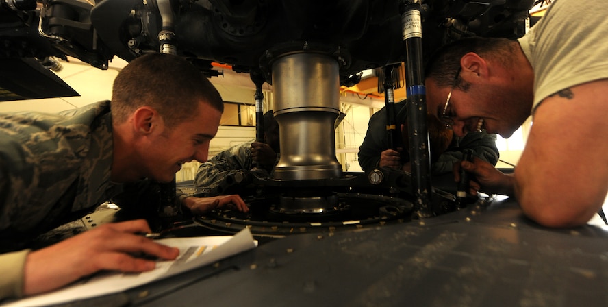 MOODY AIR FORCE BASE, Ga.-- Staff Sgt. Paul Zent, 41st Helicopter Maintenance Unit crew chief, reads serial numbers off each part under the main rotor head of an HH-60G Pave Hawk helicopter as Airman 1st Class Tyler Lecates, 41st HMU crew chief, writes them down during routine maintenance recently. The serial numbers are matched to a database to ensure all parts are accounted for and accurate. (U.S. Air Force photo/Airman 1st Class Benjamin Wiseman)(RELEASED)