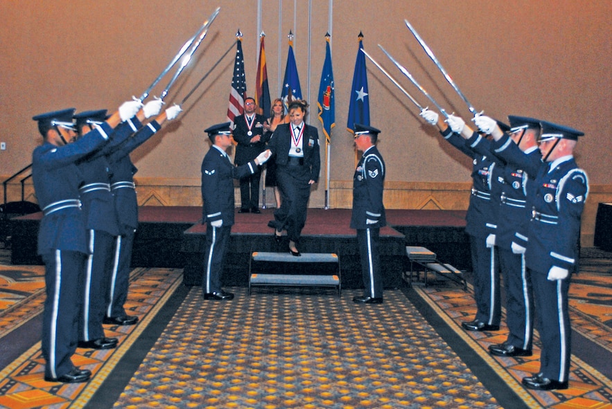 Tech. Sgt. Nina Mitcham, 56th Comptroller Squadron customer service NCO-in-charge, and NCO of the Year, walks towards the Honor Guard cordon January 29th after it being announced during the 2010 Annual Awards Banquet.  (U.S. Air Force photo/Senior Airman Tracie Forte)