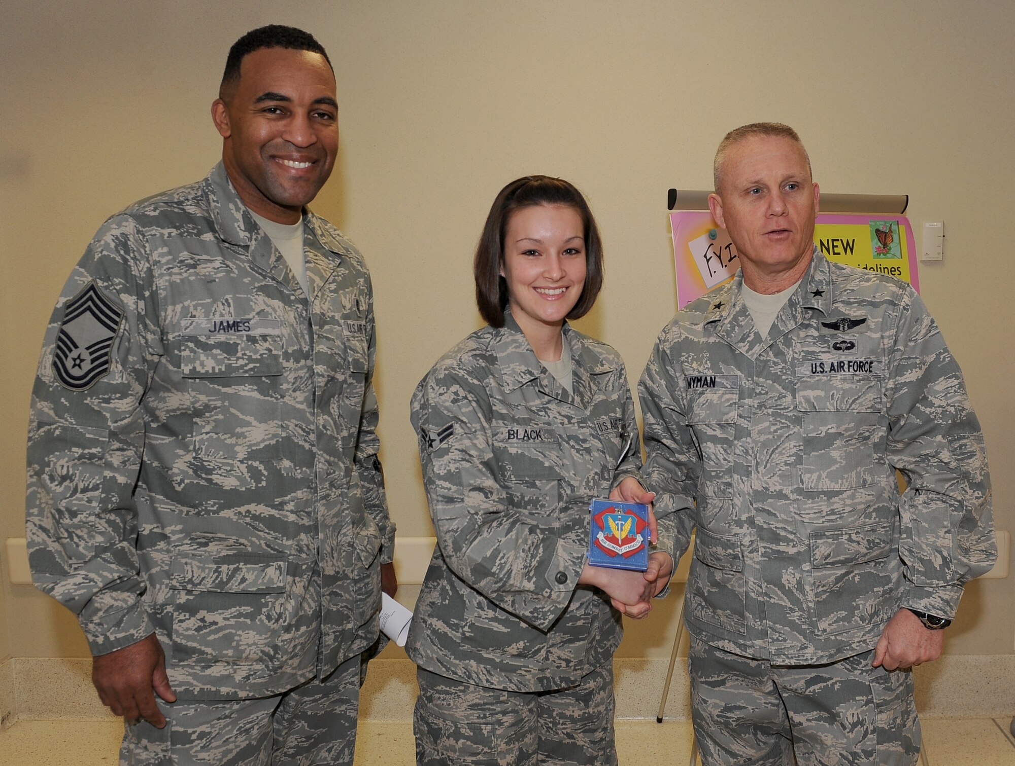 LANGLEY AIR FORCE BASE, Va. – Chief Master Sgt. Maurice James, Air Combat Command Surgeon General medical enlisted force chief, and Brig. Gen. Daniel Wyman, ACC SG, present Airman 1st Class Erin Black, 633d Medical Group Women's Health Clinic, with the ACC Outstanding Performer Award while touring USAF Hospital Langley Feb. 3. Airman Black is recognized for her contributions to the overall turnaround time for patients seen in the Women’s Health Clinic. (U.S. Air Force photo/Senior Airman Antoinette Gibson) (RELEASED)
