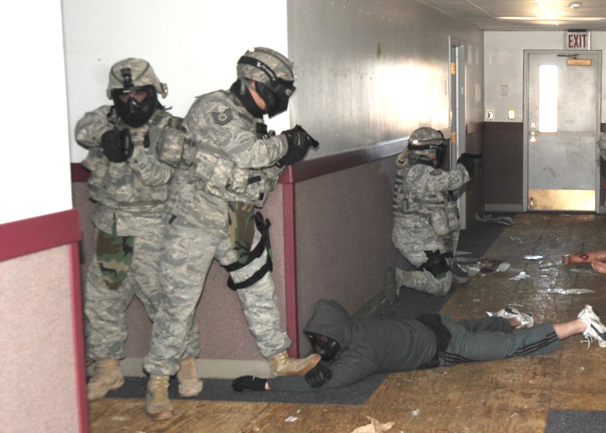 Security Forces cover a hallway after disarming the “shooter” during an active-shooter scenario.  U.S. Air Force Photo by Dennis Carlson.