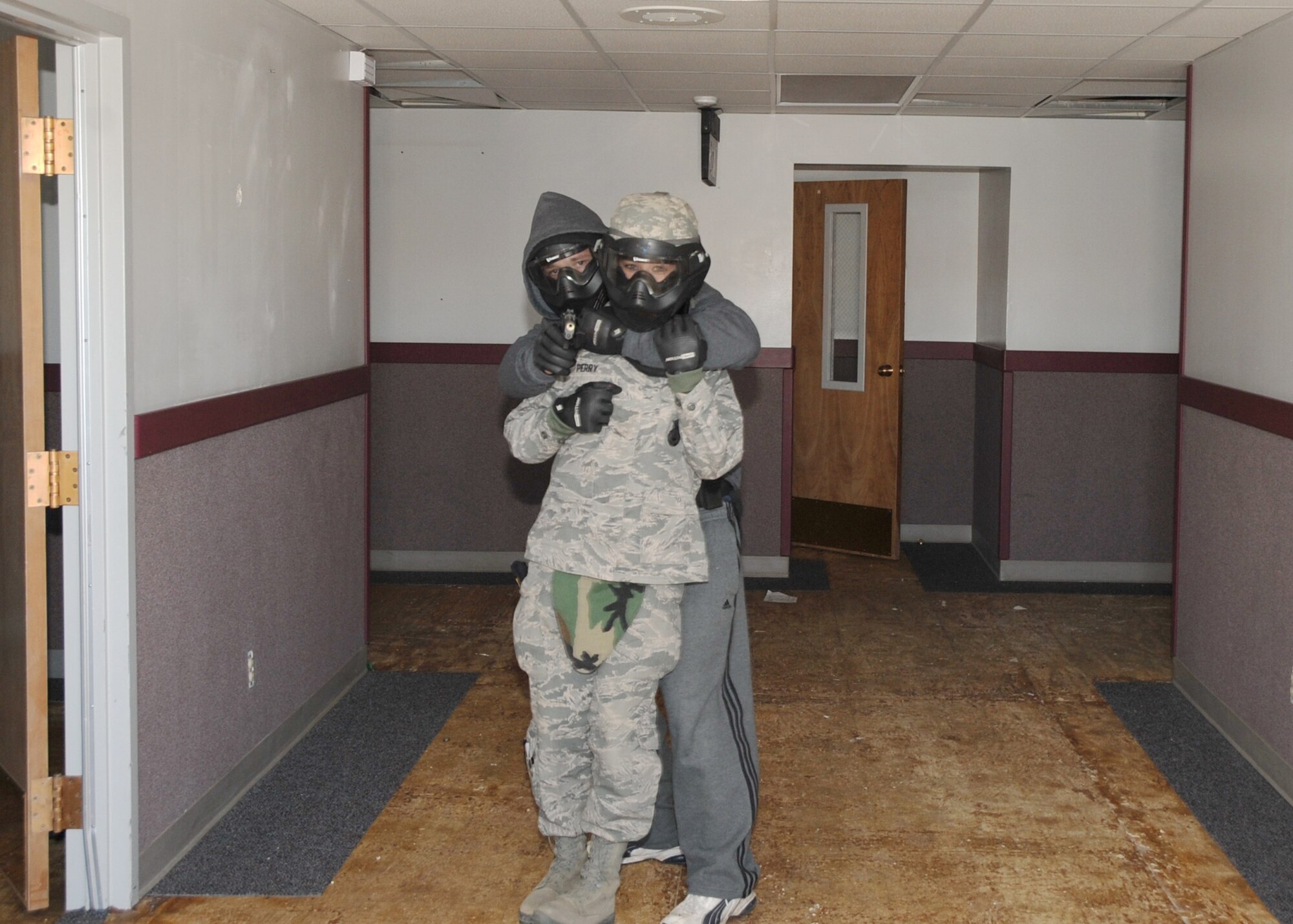 An Airman posing as a shooter holds a hostage during an active-shooter scenario.  U.S. Air Force Photo by Dennis Carlson.