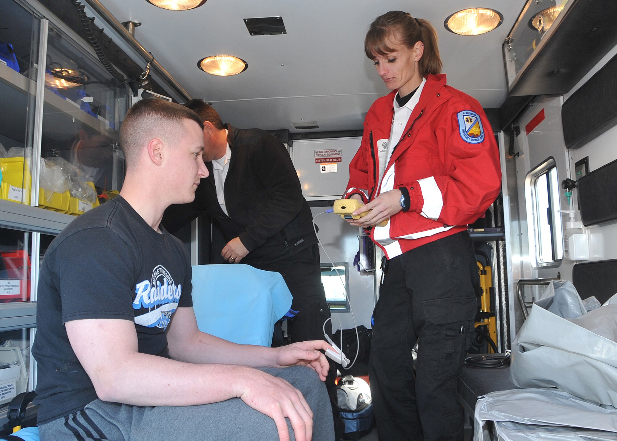 Senior Airman Daniel Jacobson, 377th Security Forces Squadron, has his vital signs checked by Albuquerque Ambulance paramedics during a suspicious-package exercise Jan. 26.  U.S. Air Force Photo by Todd Berenger