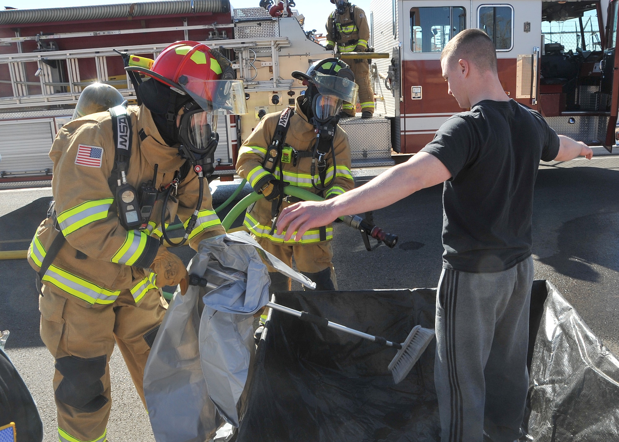 Senior Airman Daniel Jacobson, 377th Security Forces Squadron, goes through a decontamination process during the exercise.  U.S. Air Force Photo by Todd Berenger