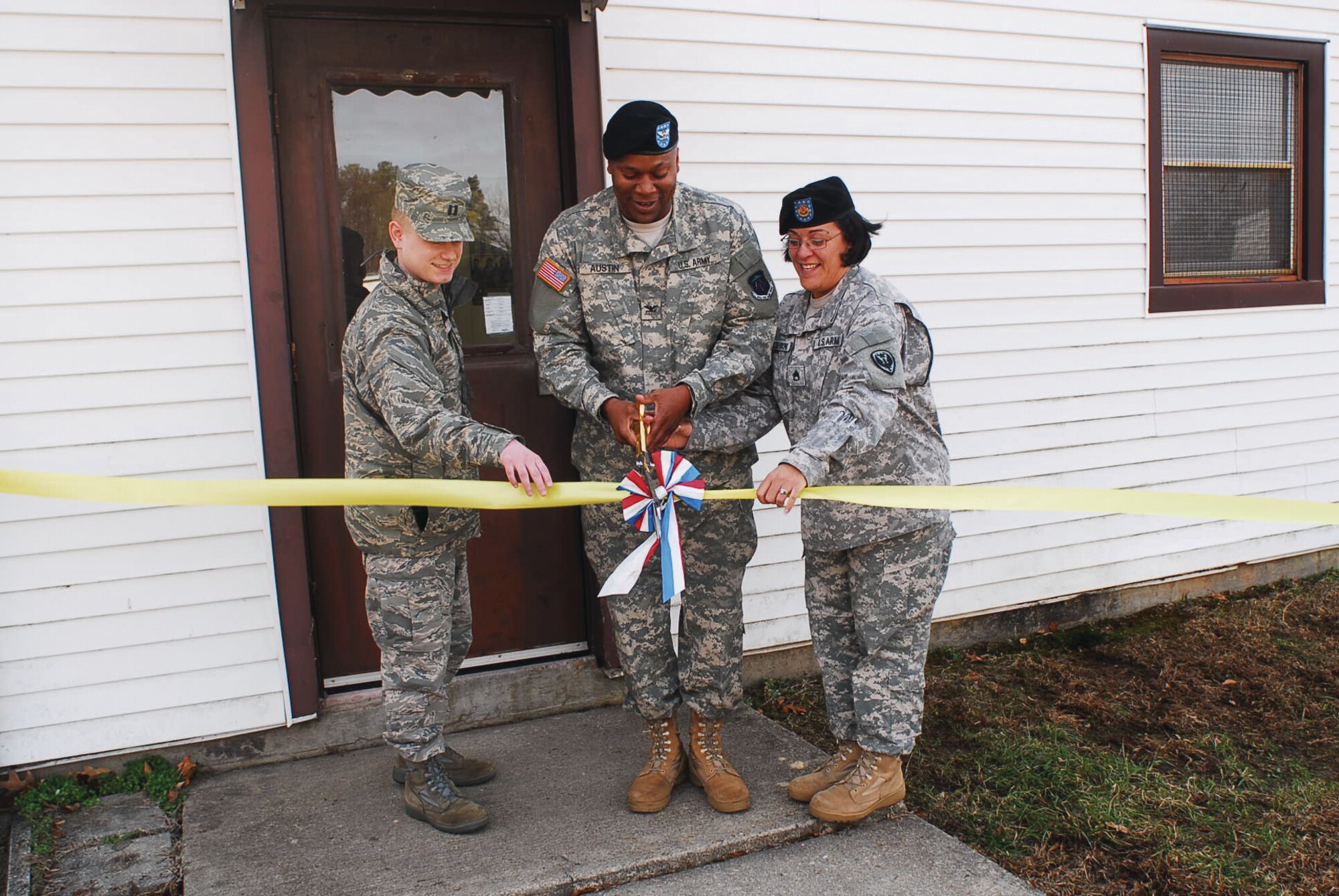 (Left) Capt. Eric Morley, Joint Base Tax Program Officer In Charge, Col. Reggie L. Austin, 633d Air Base Wing vice commander, and Staff Sgt. Loray Gonzales-Young, Fort Eustis Tax Center noncommissioned officer in charge, cut the ceremonial ribbon for the Fort Eustis Tax Center grand opening Tuesday. (Photo by Tetaun Moffett)


