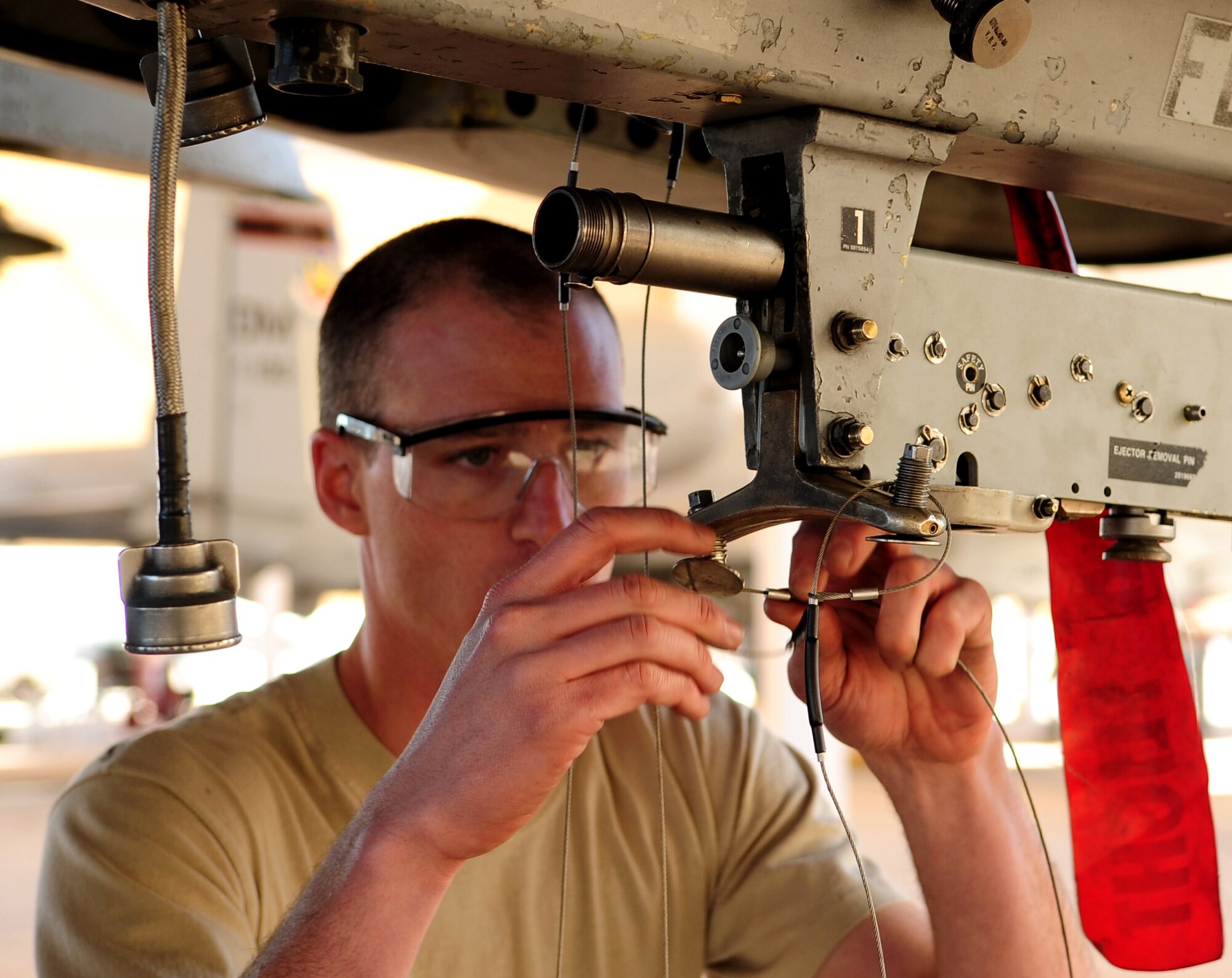 Airman 1st Class Kyle Wheatley, member of the 357th Aircraft Maintenance Unit load crew, installs a release lanyard to the sway-brace of a Triple Ejector Rack during the annual Load Crew competition on the flight line here Jan. 28. The competition determines the winners of the Load Crew of the Year award which will be announced at the Maintenance Professional of the Year banquet in February. (U.S. Air Force photo/Airman 1st Class Jerilyn Quintanilla) 