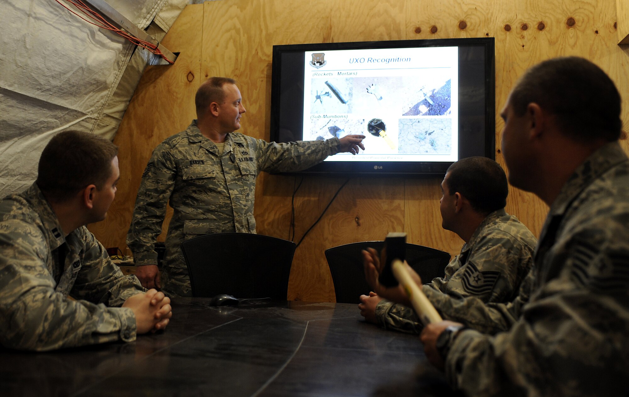 Tech. Sgt. Mark Hansen gives a briefing about recognizing unexploded ordinance Feb. 04, 2011, at Kandahar Airfield, Afghanistan. Sergeant Hansen develops emergency response plans and trains more than 200 Airmen to be representatives for the emergency operations centers, PAR teams, and to be emergency management representatives within their units. Sergeant Hansen is the emergency manager assigned to the 451st Expeditionary Civil Engineering Squadron. (U.S. Air Force photo/Senior Airman Willard E. Grande II/Released)