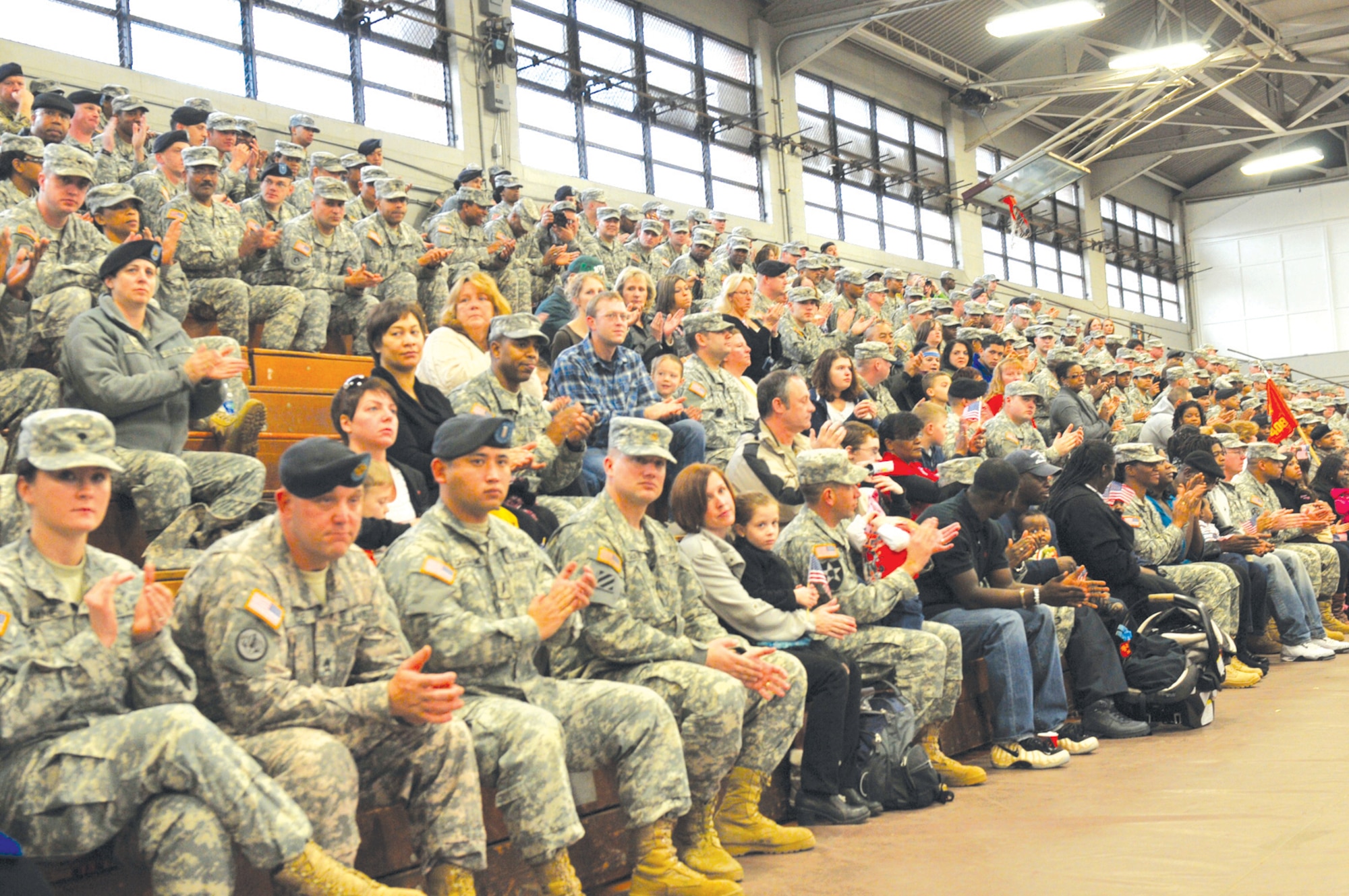Soldiers, family and friends fill the bleachers at Fort Eustis’ Anderson Field House during the 7th Sust. Bde.’s deployment ceremony. The brigade command team formally cased the unit colors, a time-honored military tradition symbolizing the official movement of the commander and his troops to a forward location.