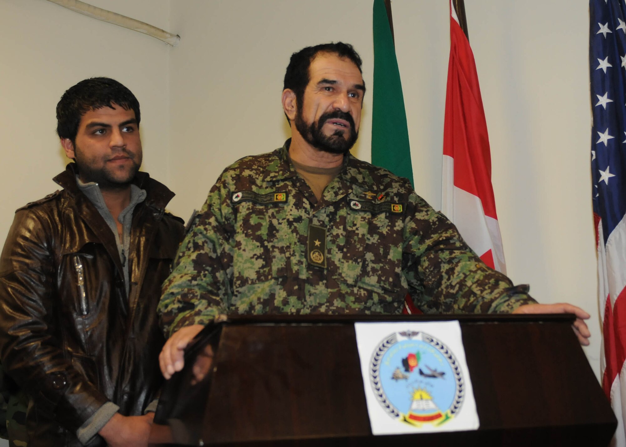 KABUL, Afghanistan - Brig. Gen. Barat, Kabul Air Wing Commander, speak to members of the Afghan Air Force,including the first female graduate Sgt. Shakeela Rasa, and Afghan civilians who graduated from the Airman Basic Intelligence Course at the Pohantoon-e-Hawayee, the Afghan Air Force's "Big Air School", in Kabul, Afghanistan on Feb. 3rd. (U.S. Navy photo by Mass Communications Specialist 3rd Class Petty Officer Jared E. Walker).