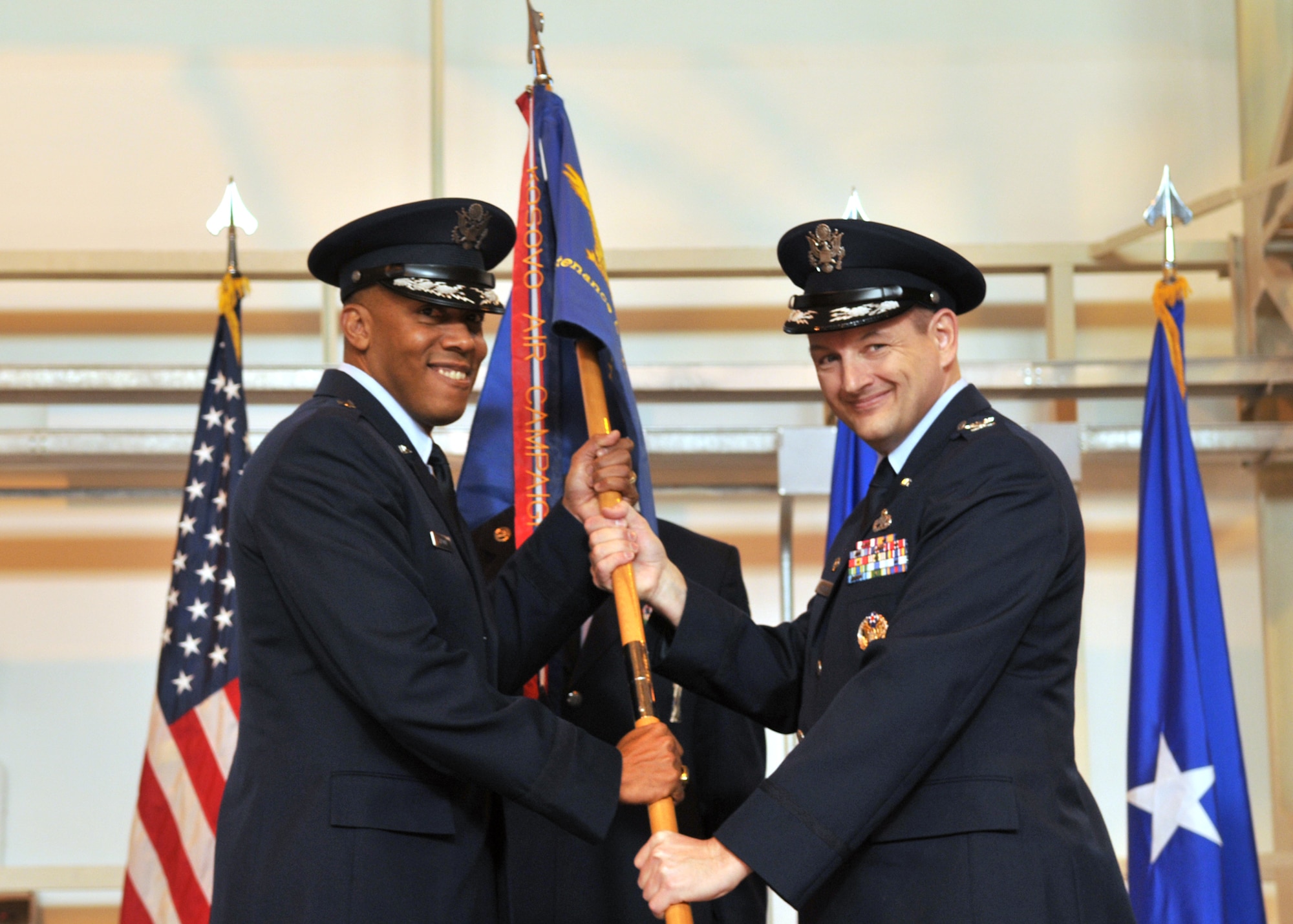 Brig. Gen. C.Q. Brown Jr., 31st Fighter Wing commander, presents Col. Fredrick Plaumann, 31st Maintenance Group commander, the group flag during the 31st MXG change of commander ceremony Feb. 3 at Hangar 2 here. Colonel Plaumann replaced Col. Dennis Shumaker as the group commander. (U.S. Air Force photo/Staff Sgt. MercedesKimble Crossland)