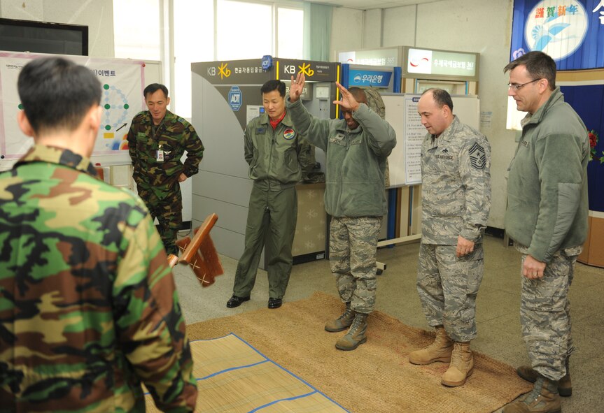 KUNSAN AIR BASE, Republic of Korea -- Col. Ronald Jolly, 8th Maintenance Group commander, plays the traditional Korean game of Yut during a Lunar New Year ceremony in the Republic of Korea Air Force base exchange Feb. 3. The combined 8th Fighter Wing and ROKAF 38th Fighter Group ceremony included a memorial service, ceremonial bowing, a traditional Korean breakfast and traditional games. (U.S. Air Force photo/Senior Airman Ciara Wymbs)