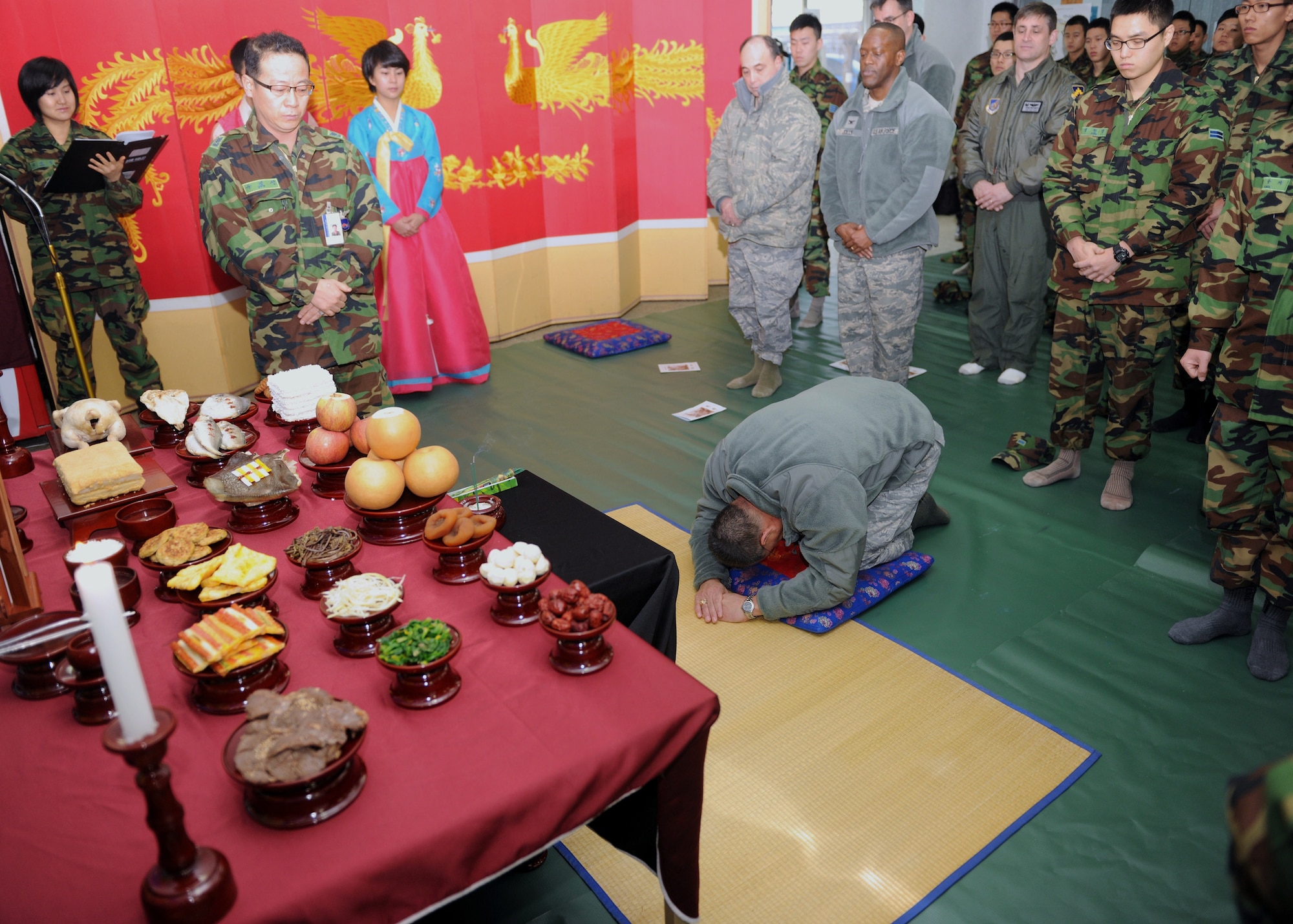 KUNSAN AIR BASE, Republic of Korea -- Col. Steven Caberto, 8th Medical Group commander, bows to ancestors during a memorial service held during a Lunar New Year ceremony in the Republic of Korea Air Force base exchange Feb. 3. The combined 8th Fighter Wing and ROKAF 38th Fighter Group ceremony included the memorial service, ceremonial bowing, a traditional Korean breakfast and traditional games. (U.S. Air Force photo/Senior Airman Ciara Wymbs)