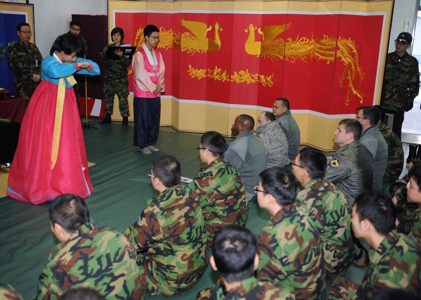 KUNSAN AIR BASE, Republic of Korea -- Two Republic of Korea Air Force 38th Fighter Group members demonstrate how to bow during a Lunar New Year ceremony in the ROKAF base exchange Feb. 3. The combined 8th Fighter Wing and ROKAF 38th FG ceremony included a memorial service, ceremonial bowing, a traditional Korean breakfast and traditional games. (U.S. Air Force photo/Senior Airman Ciara Wymbs)