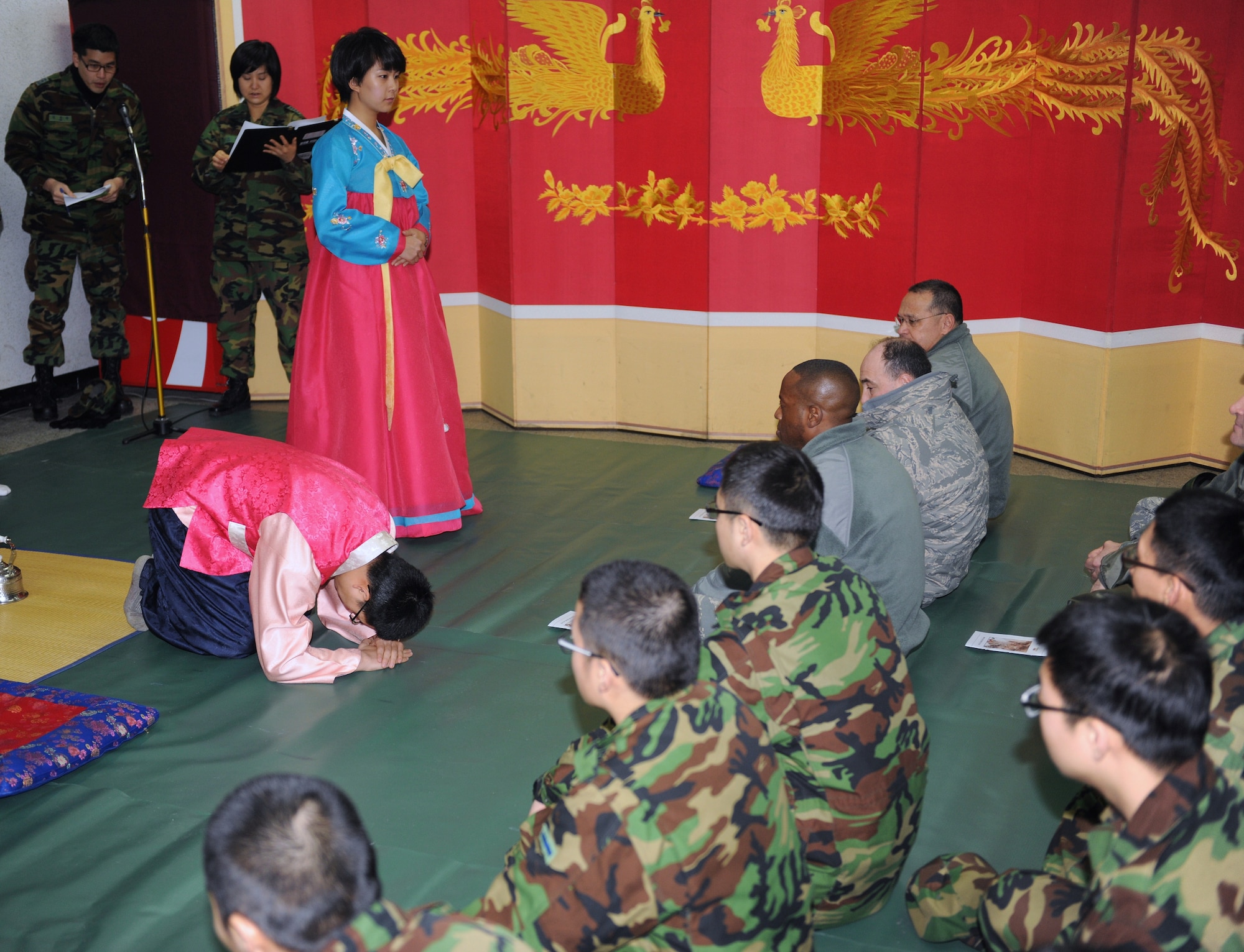 KUNSAN AIR BASE, Republic of Korea -- Two Republic of Korea Air Force 38th Fighter Group members demonstrate how to bow during a Lunar New Year ceremony in the ROKAF base exchange Feb. 3. The combined 8th Fighter Wing and ROKAF 38th FG ceremony included a memorial service, ceremonial bowing, a traditional Korean breakfast and traditional games. (U.S. Air Force photo/Senior Airman Ciara Wymbs)