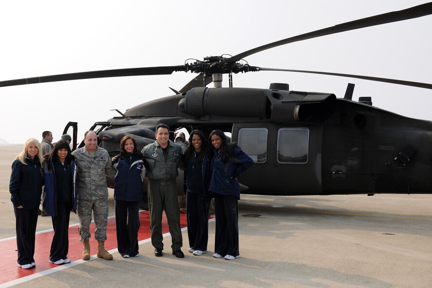 KUNSAN AIR BASE, Republic of Korea --  Cheerleaders representing the National Football League's Houston Texans pose for a photo with Col. Hugh Hanlon, 8th Fighter Wing vice commander and Chief Master Sgt. James Sanders, 8th FW command chief, shortly after arriving on base via helicopter Feb. 3.  During their stay, the cheerleaders signed autographs and posed for pictures with Wolf Pack Airmen.(U.S. Air Force photo/Tech. Sgt. Jonathan Pomeroy)