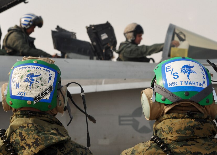 Marine pilots and maintainers from the Marine Fighter Attack Squadron 225 prepare an F-18 Hornet prior to takeoff at Osan Air Base, Republic of Korea, Feb. 2. The Marine squadron is currently on their unit deployment program, where they go to Marine Corps Air Station Iwakuni for six months in which they travel around the Pacific for a few weeks at a time to train their aircrew in different environments. (U.S. Air Force photo/Senior Airman Evelyn Chavez)