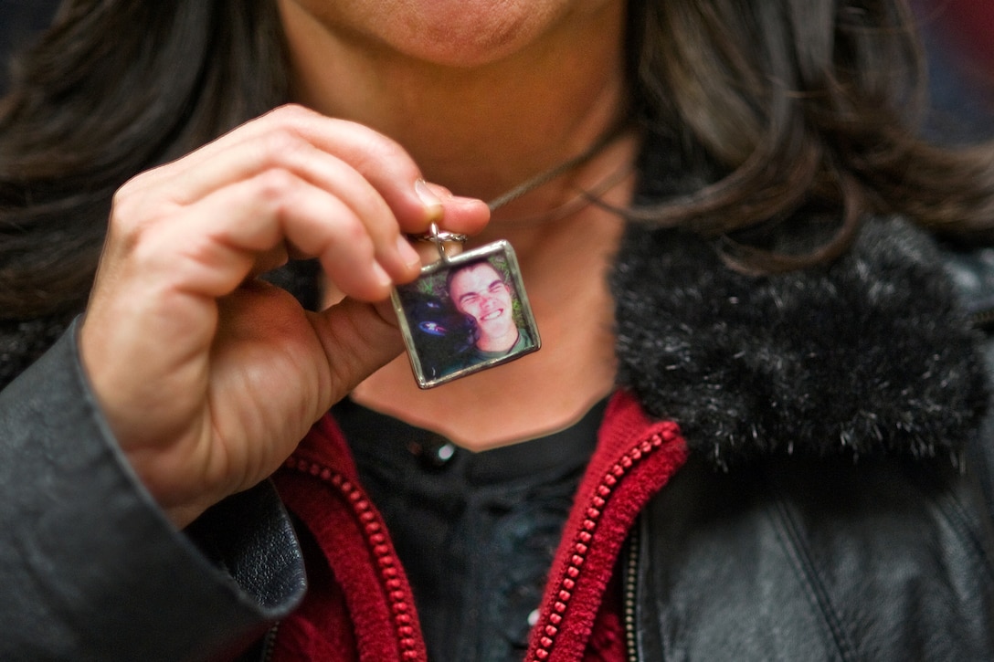 Kathy Rusk shows a pendant with a picture of her son, U.S. Marine Corps ...