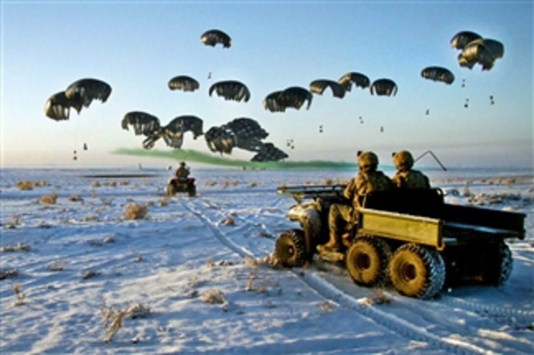 U.S. Army soldiers in four-wheel drive vehicles wait as bundles of fuel are air delivered by a C-17 Globemaster III to Forward Operating Base Waza K'wah in Paktika province, Afghanistan, on Jan. 30, 2011.  The soldiers are assigned to the 101st Airborne Division's 4th Brigade Combat Team.  