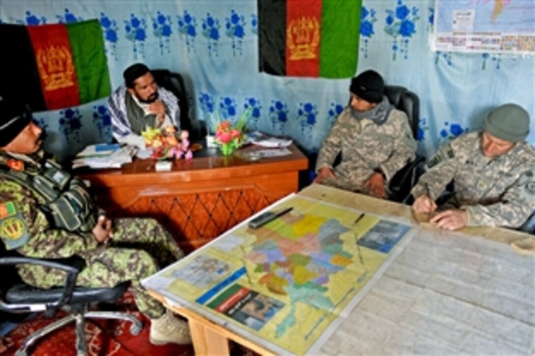 Afghan Army Col. Mohammed Dost, left, and U.S. Army Maj. Trever Nehls, right, talk with Shamulzai District Gov. Haji Faisal Bari during a trip to the Afghanistan district, Feb. 2, 2011. Dost and members of Provincial Reconstruction Team Zabul traveled to Shamulzai to meet with Afghan forces and discuss district issues with the new governor.