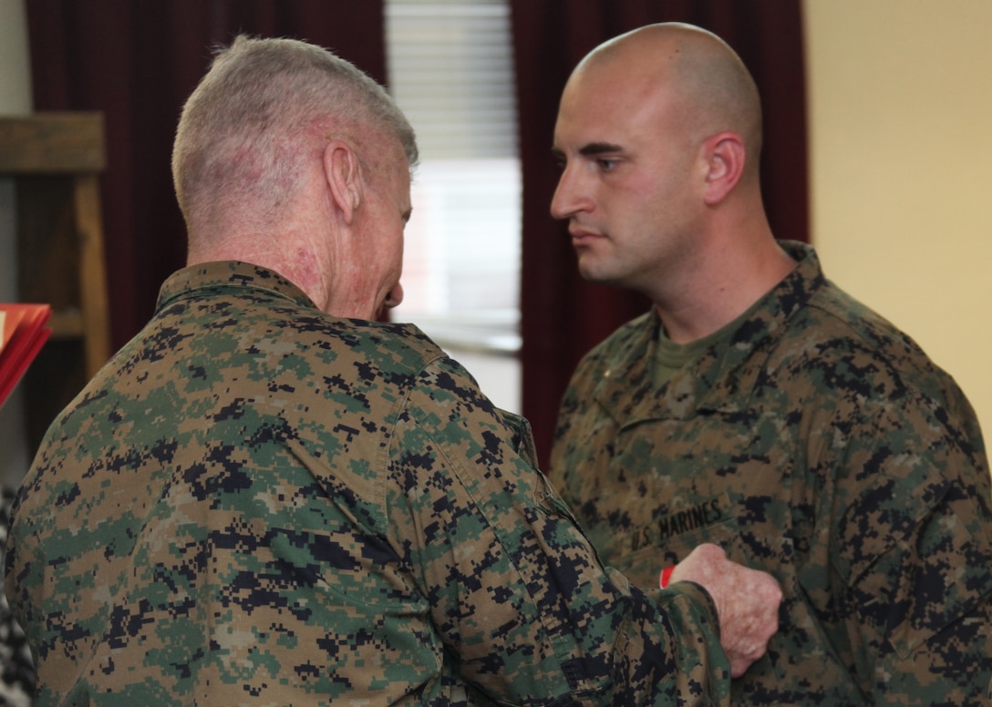 Chief Warrant Officer Marine Gunner Paul Sandy, right, a Swansea, S.C., native and the battalion gunner with Battalion Landing Team, 2nd Battalion, 2nd Marine Regiment, 22nd Marine Expeditionary Unit, stands in a formation just before receiving a Bronze Star Medal with Combat Distinguishing Device during a ceremony at the battalion headquarters aboard Marine Corps Base Camp Lejeune, N.C., Feb. 4, 2011.  Sandy received his Bronze Star Medal for heroic actions while deployed to Afghanistan in 2010.