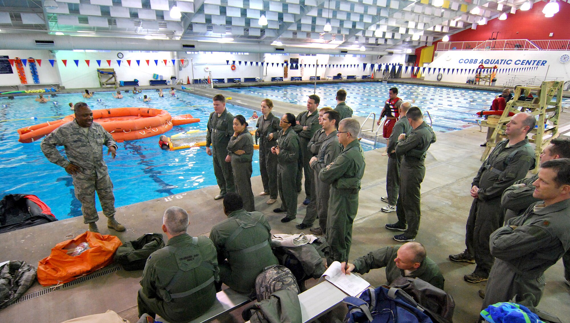 Master Sgt. Mike Varnado, Aircrew Flight Equipment Training NCOIC, briefs 94th Airlift Wing aircrew members on the water survival training they will receive at the Cobb Aquatic Center in Marietta, Ga., 4 Feb.  Aircrew members are required to receive this training once every three years to stay proficient with the equipment and techniques used in a water survival situation.  The Aircrew Flight Equipment Continuation instructors conduct this training twice a year and have partnered with Cobb County to use this facility for each winter session to ensure a safe training environment.  (U.S. Air Force photo/ Brad Fallin)