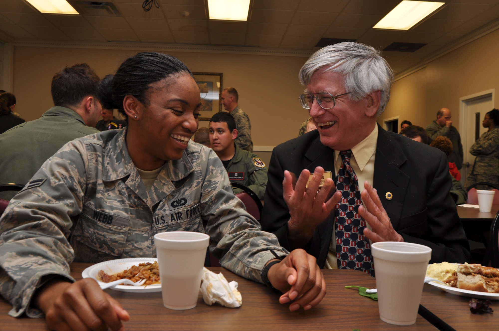 Airman 1st Class Devondra Webb, 49th Fighter Training Squadron aviation resource management apprentice, shares some food and a laugh with LINK member Andy Kalinowski at the Jan. 27 Dorm Dinner in Chapel Annex. (U.S. Air Force photo/Airman 1st Class Chase Hedrick).